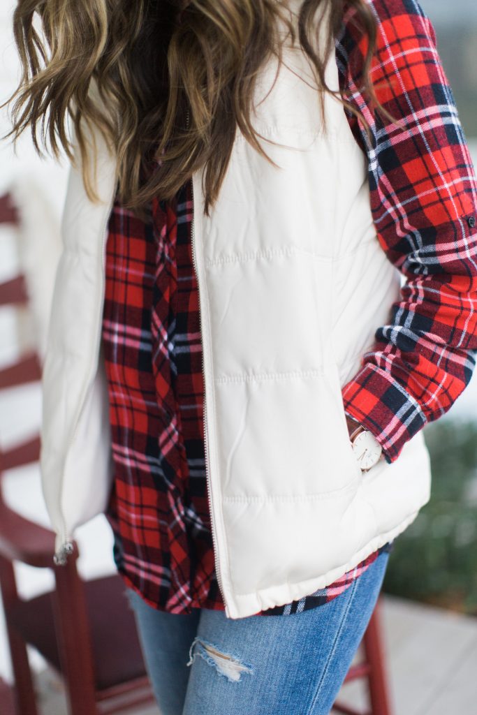 A casual holiday outfit with a plaid shirt, white puffer vest, and red Hunter boots is perfectly comfortable and festive.