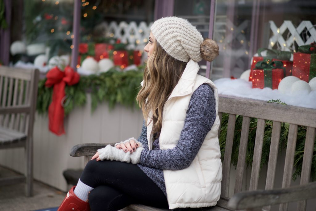 Cozy casual mom outfit with red Hunter boots, leggings, an oversized sweater, and puffy vest.