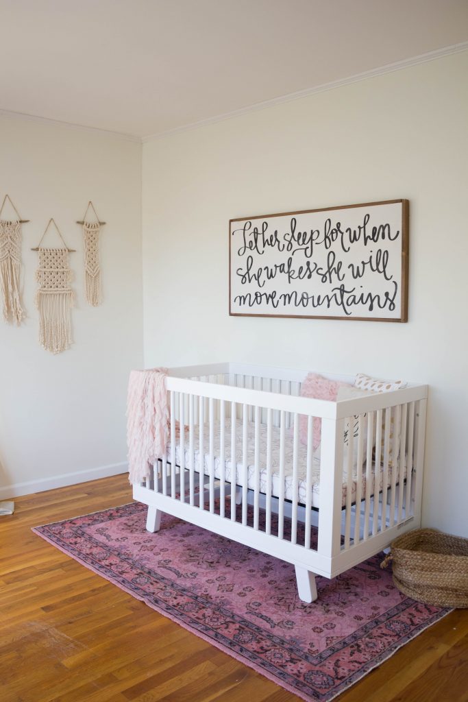 A gorgeous boho glam baby girl nursery, featuring the Babyletto Hudson Crib and Delta Children Avery Glider