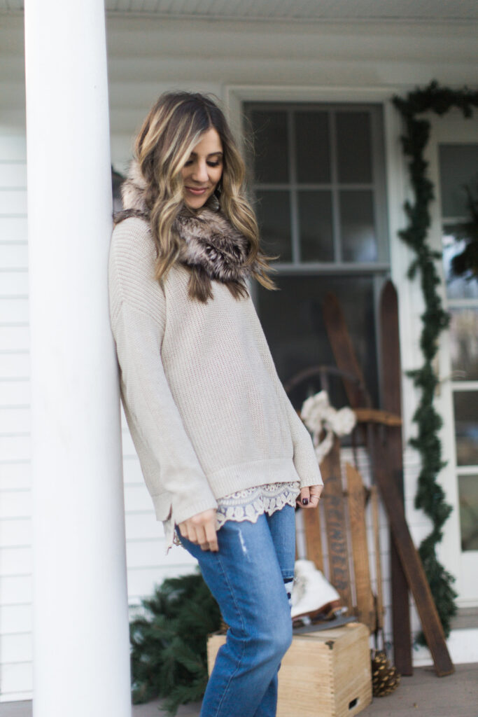 Lace trim sweater with boyfriend jeans and a faux fur scarf, winter style