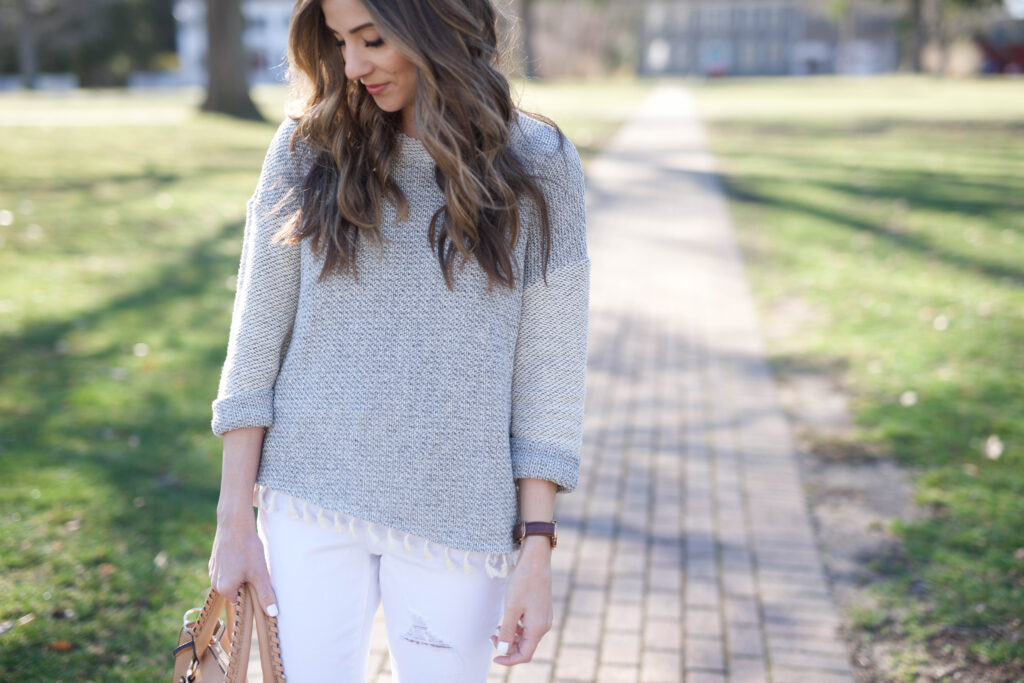 This lightweight boho fringe sweater is perfect paired with distressed white skinnies for spring fashion