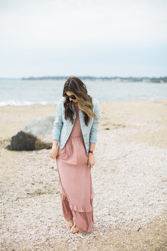 Ruffled maxi dress styled with casual studded sandals and a denim jacket