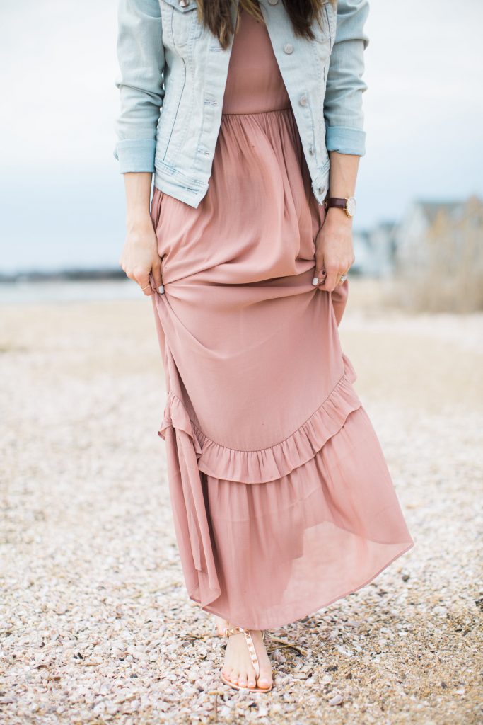 Ruffled maxi dress styled with casual studded sandals and a denim jacket