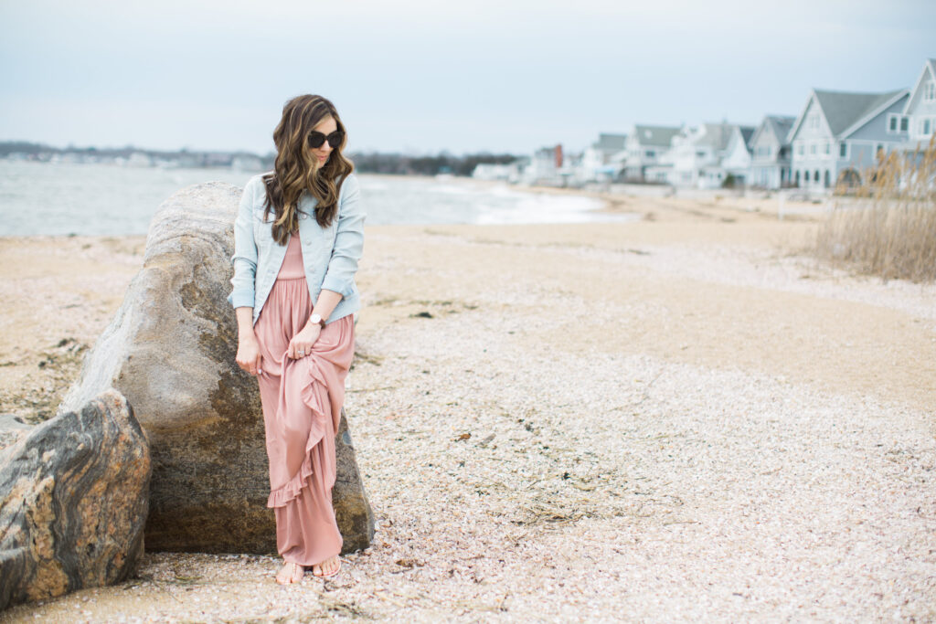 Ruffled maxi dress styled with casual studded sandals and a denim jacket