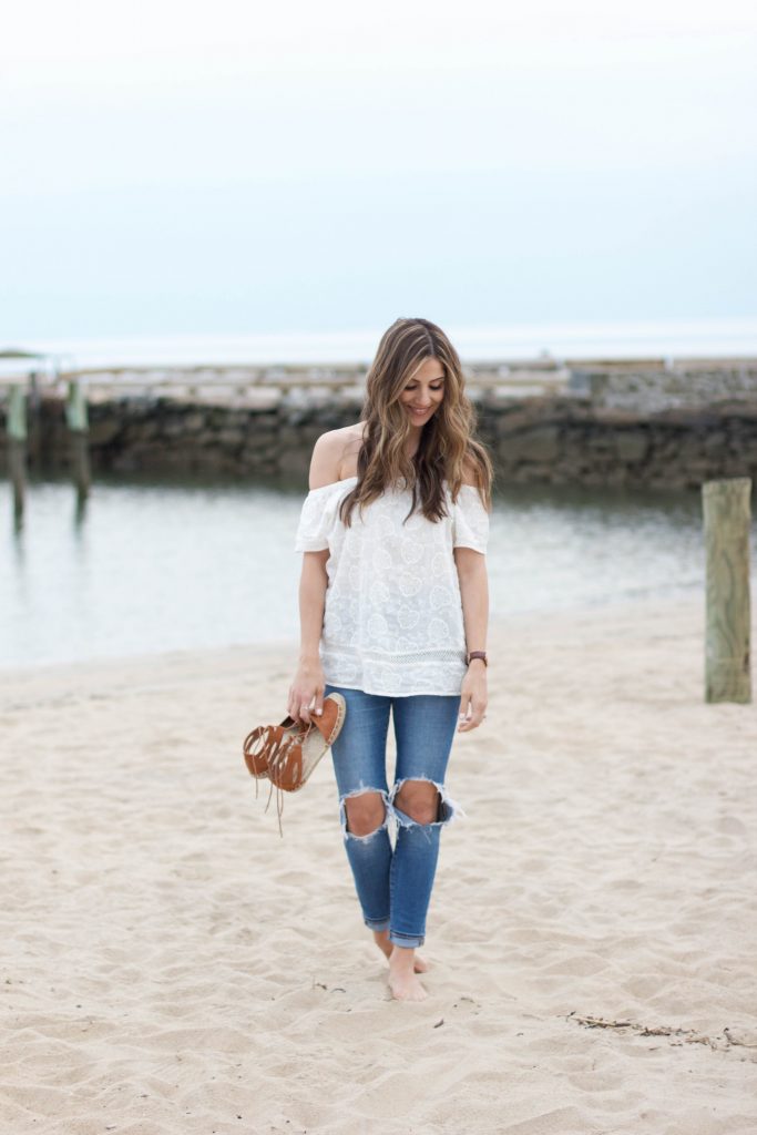 Spring style with a white off shoulder top and distressed jeans