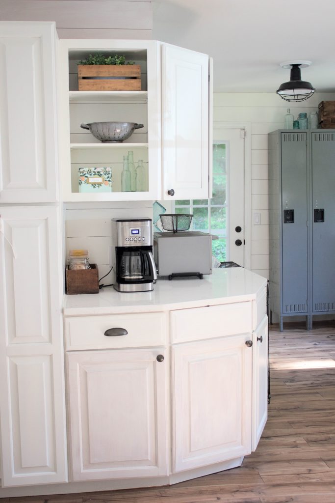 Farmhouse kitchen with shiplap walls, quartz countertops, and vintage accents