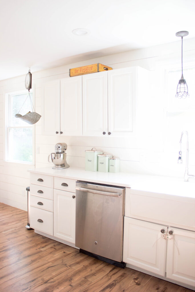 Farmhouse kitchen with shiplap walls, quartz countertops, and vintage accents