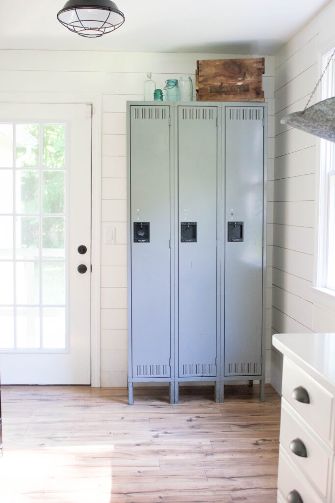 Farmhouse kitchen with shiplap walls, quartz countertops, and vintage accents