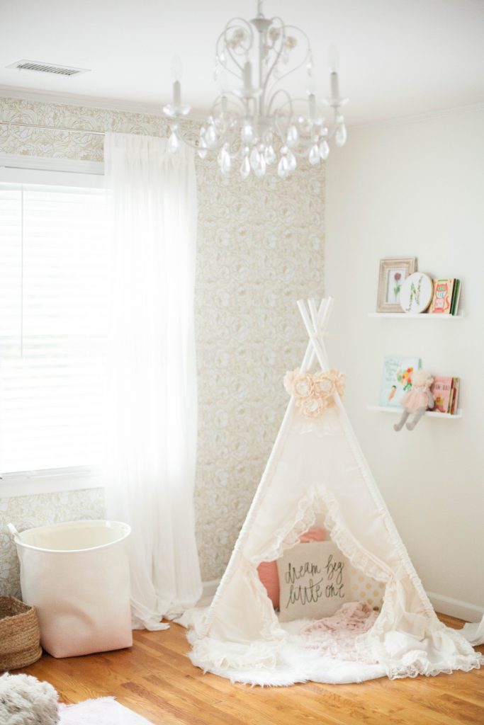 A whimsical, bohemian girl's nursery with removable wallpaper and glam accents