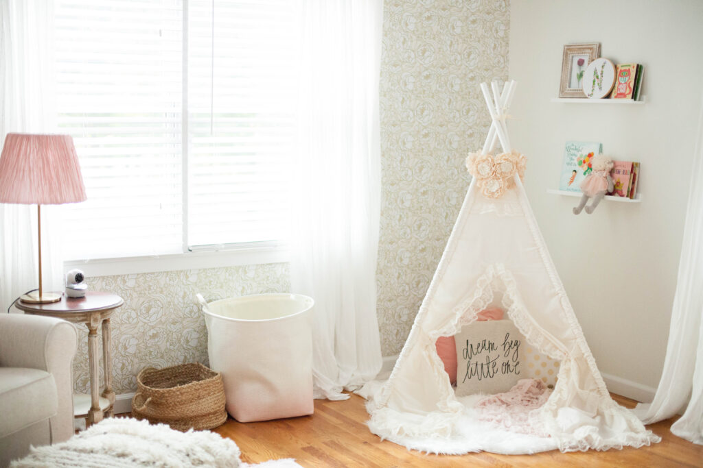 A whimsical, bohemian girl's nursery with removable wallpaper and glam accents