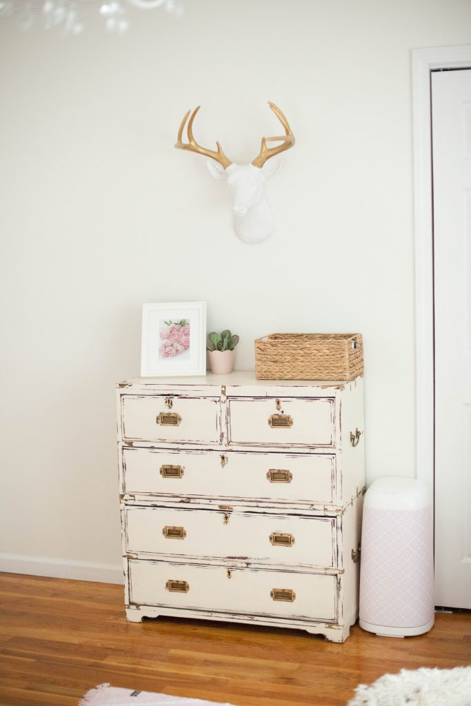 A whimsical, bohemian girl's nursery with removable wallpaper and glam accents