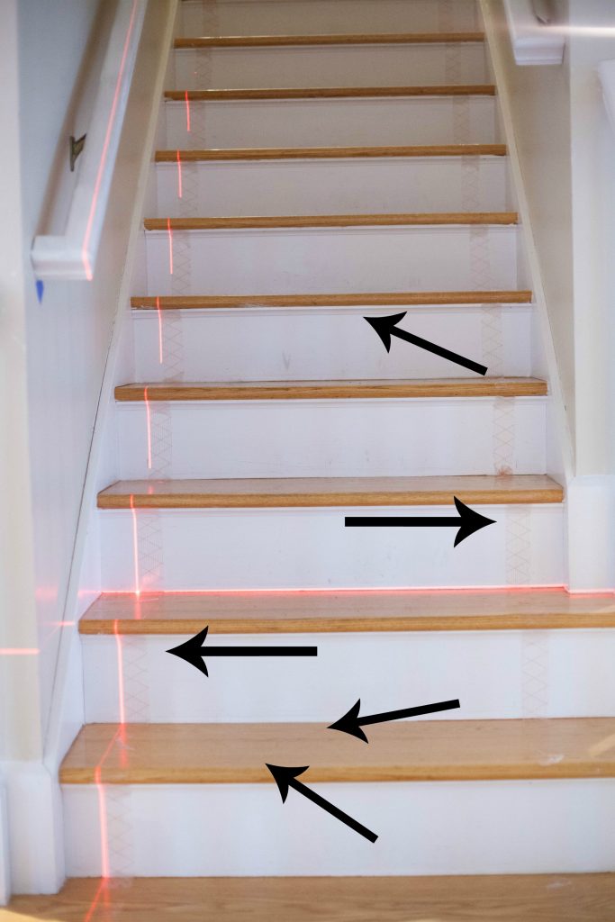 A simple guide to making a DIY stair runner using area rugs and carpet tape for a low cost solution for loud stairs!