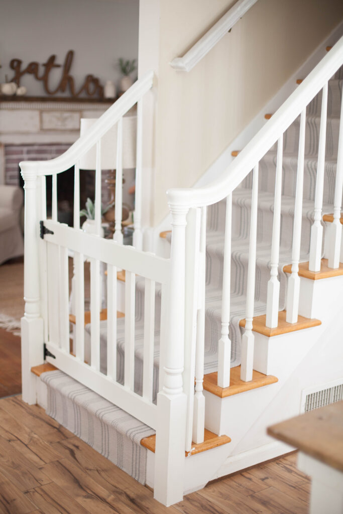 A simple guide to making a DIY stair runner using area rugs and carpet tape for a low cost solution for loud stairs!