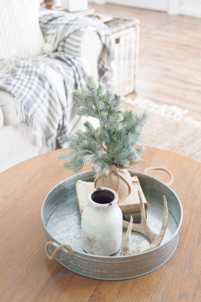 A simple and rustic farmhouse Christmas living room featuring a mixture of textures and vintage finds!