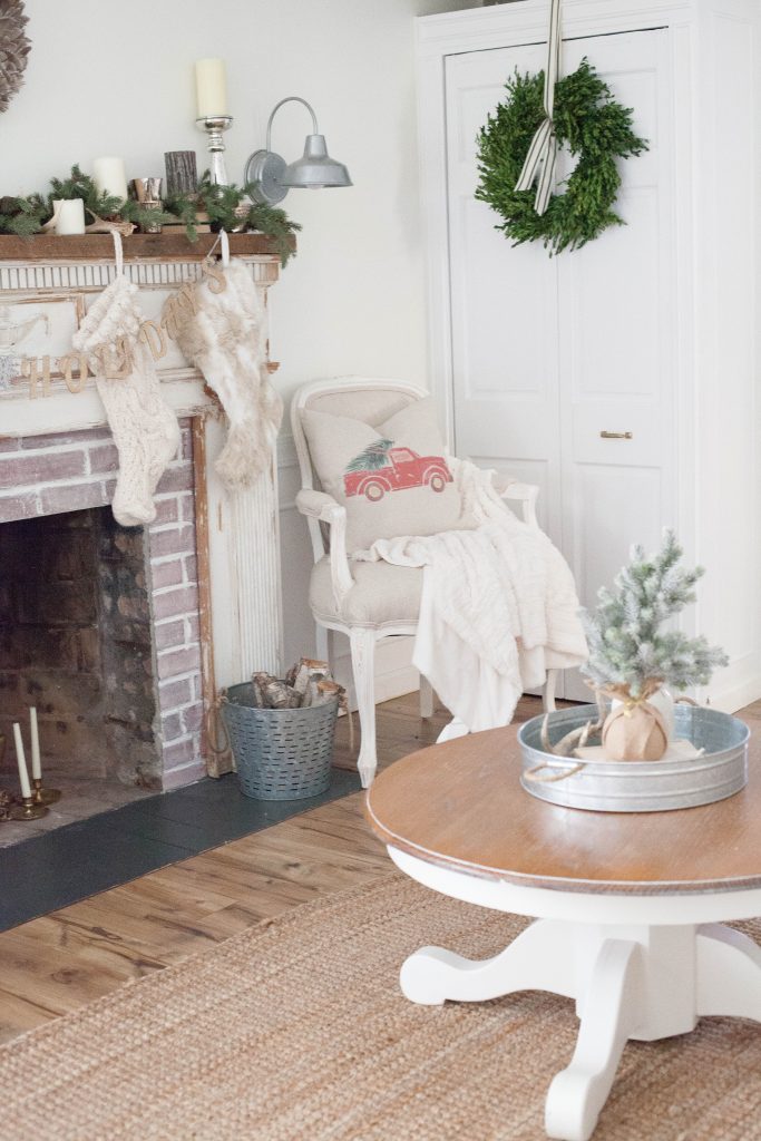 A simple and rustic farmhouse Christmas living room featuring a mixture of textures and vintage finds!