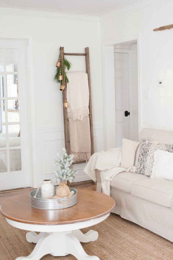 A simple and rustic farmhouse Christmas living room featuring a mixture of textures and vintage finds!