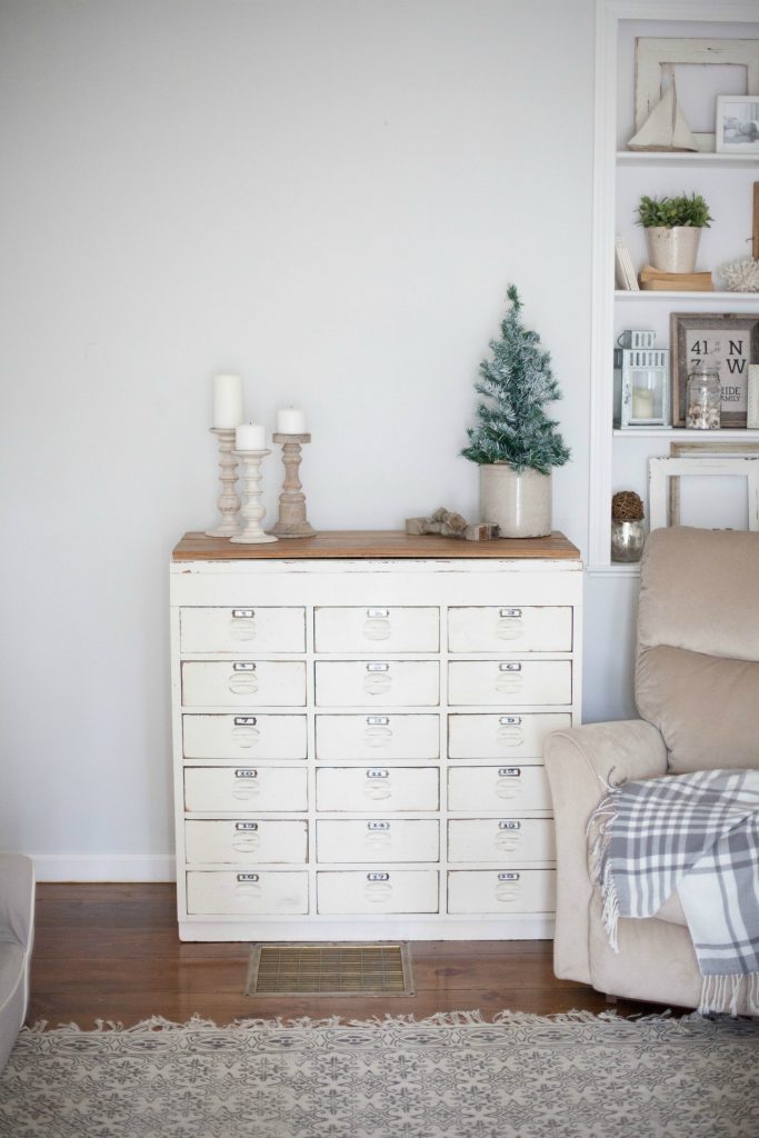 A cottage style playroom that functions as a family room as well, while keeping it kid-friendly with a variety of storage options for easy pick up.