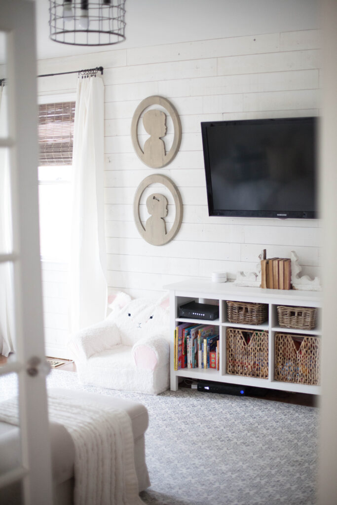 A cottage style playroom that functions as a family room as well, while keeping it kid-friendly with a variety of storage options for easy pick up.
