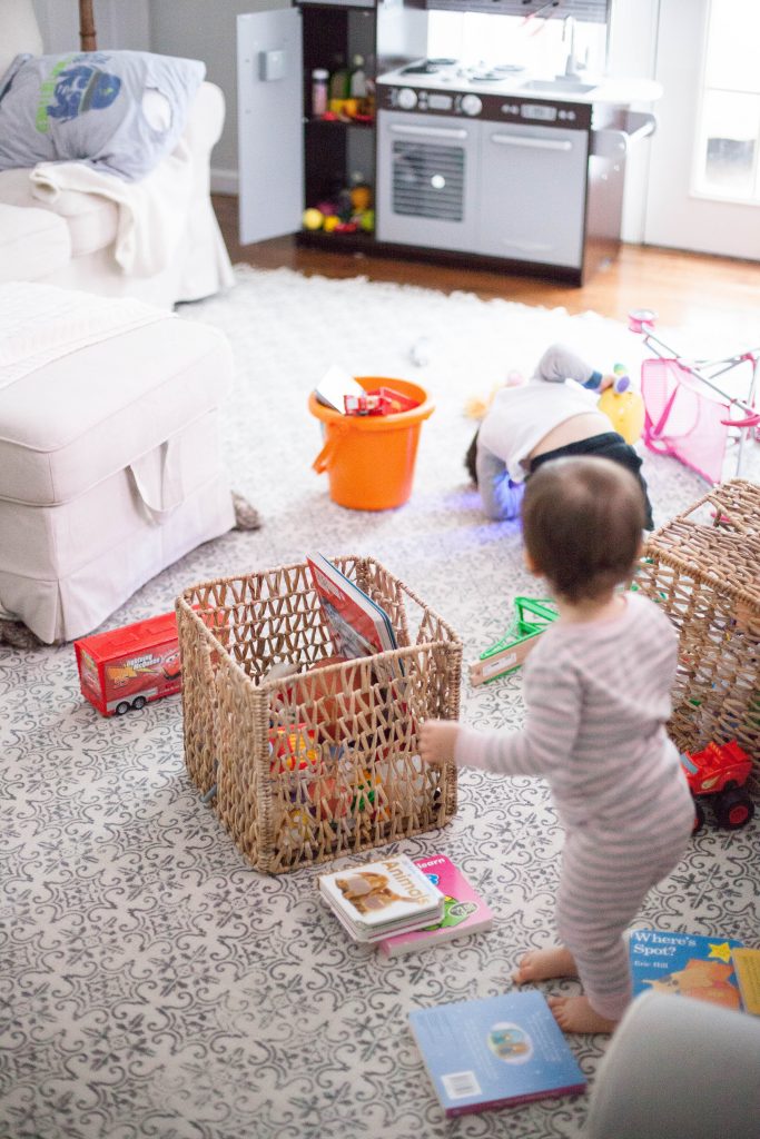 A cottage style playroom that functions as a family room as well, while keeping it kid-friendly with a variety of storage options for easy pick up.