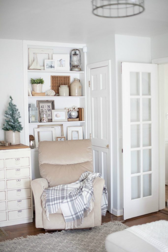 A cottage style playroom that functions as a family room as well, while keeping it kid-friendly with a variety of storage options for easy pick up.