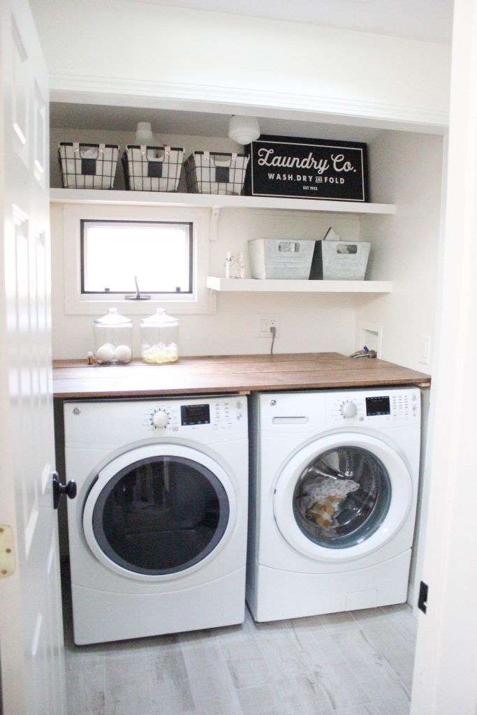 A budget-friendly farmhouse laundry room that's small, yet makes a large impact. The space is not only pretty, but functional for your laundry needs!