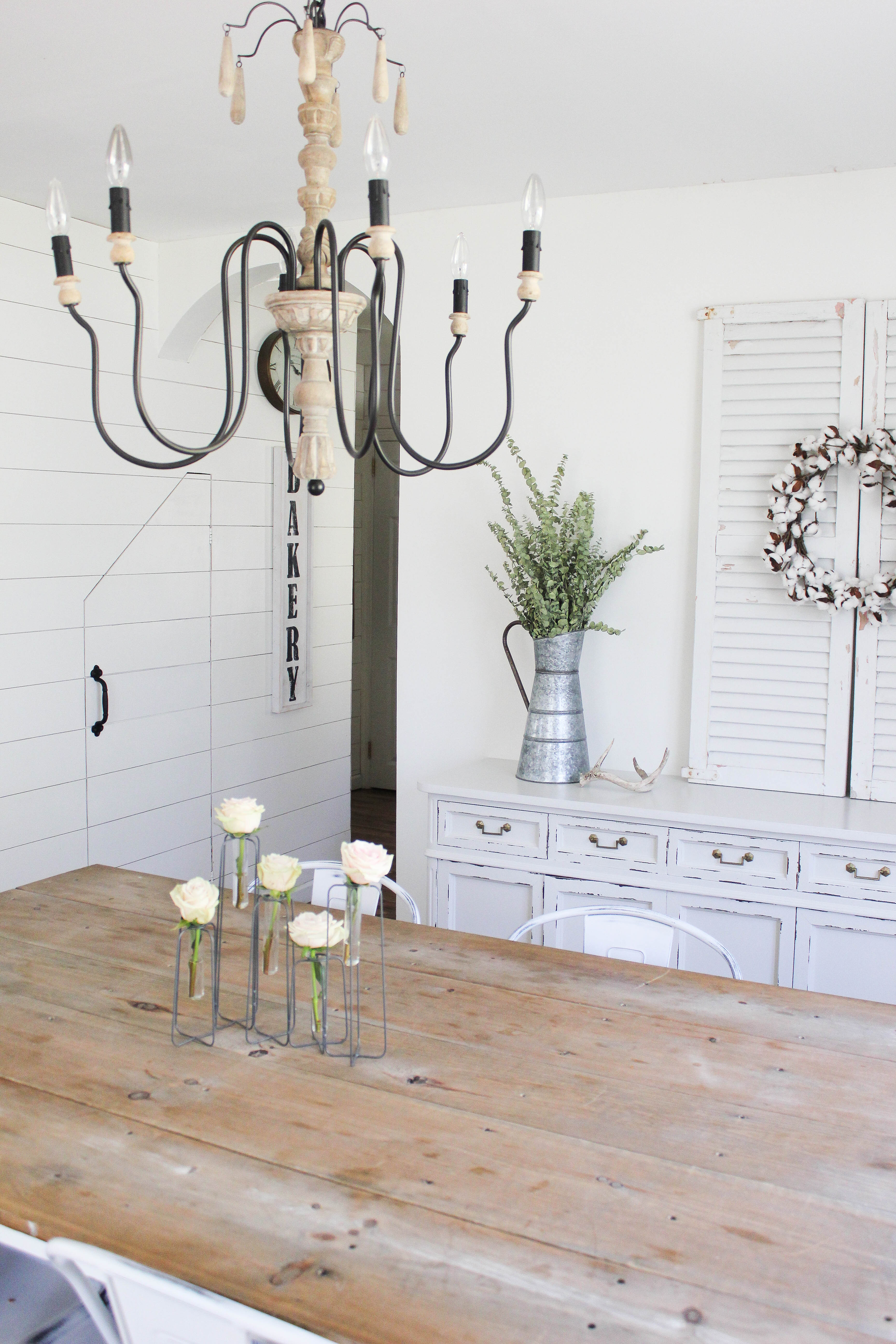 This spring cottage dining room has a mix of textures and is complete with a handmade farm table