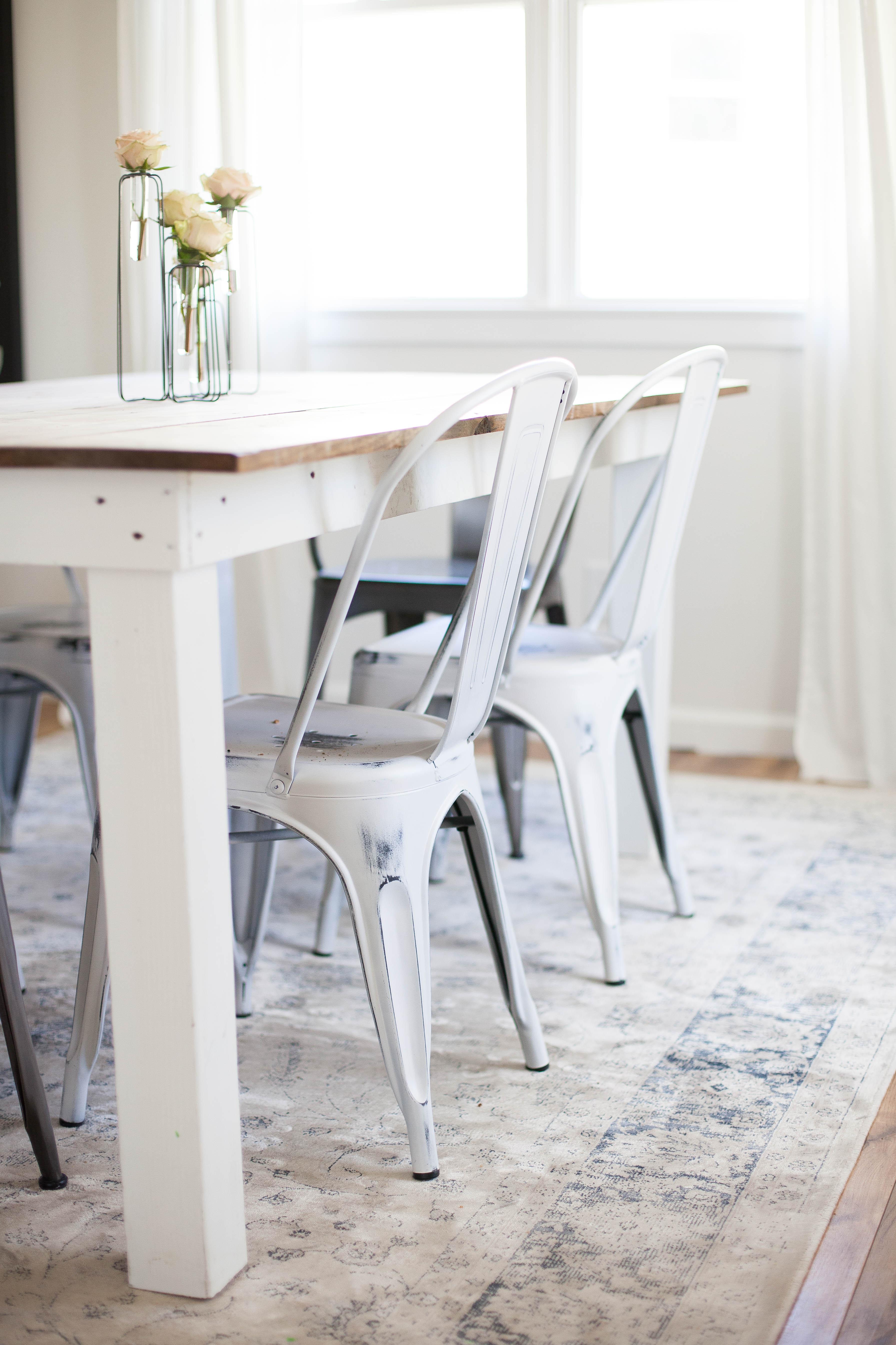 Spring cottage dining room featuring Safavieh Vintage Oriental Stone / Blue Rug and metal distressed Tolix chairs