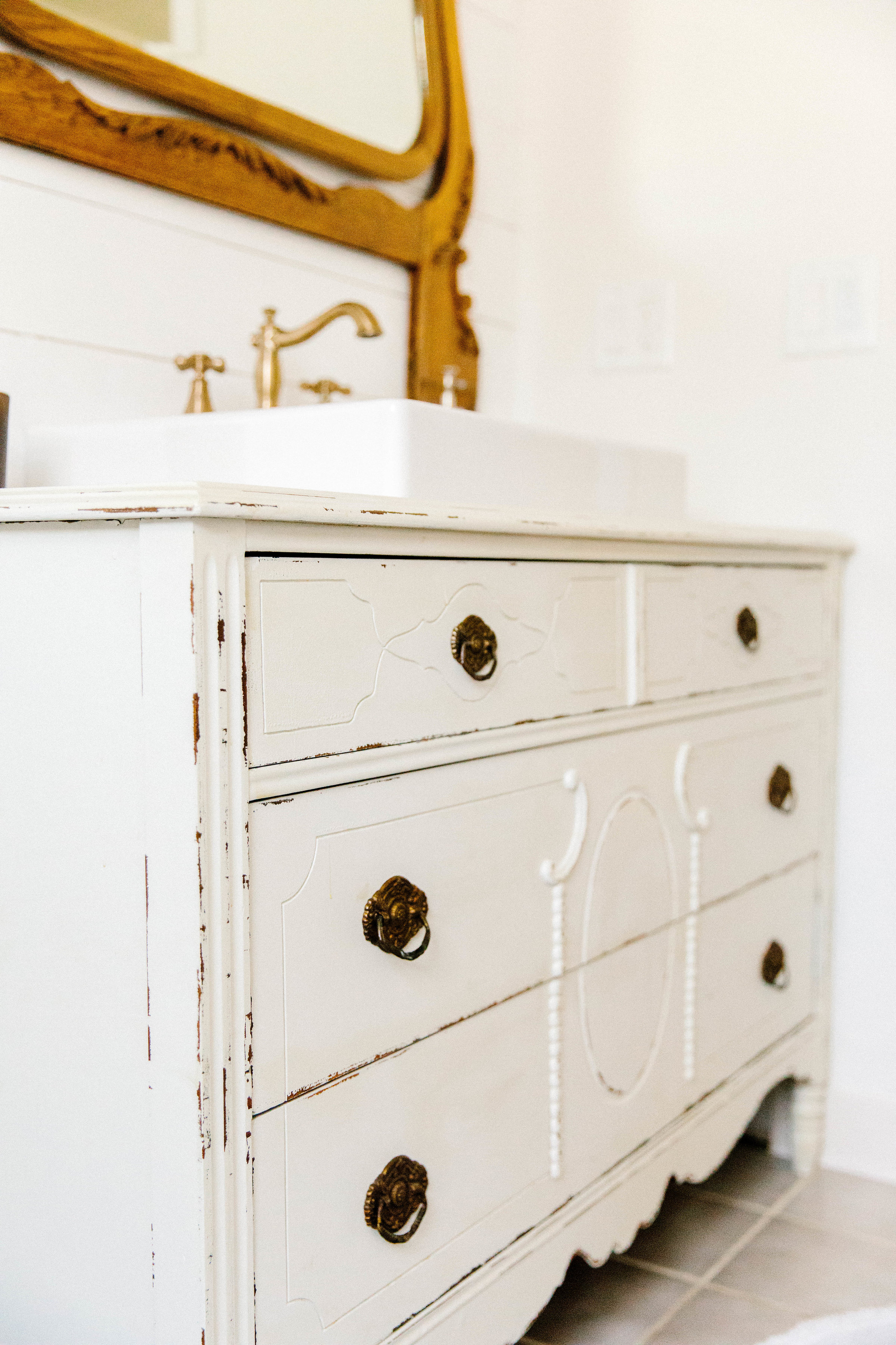 A simple tutorial on how to make a vintage dresser vanity using a vintage dresser and strategic cutting with the additional of a farmhouse sink. 