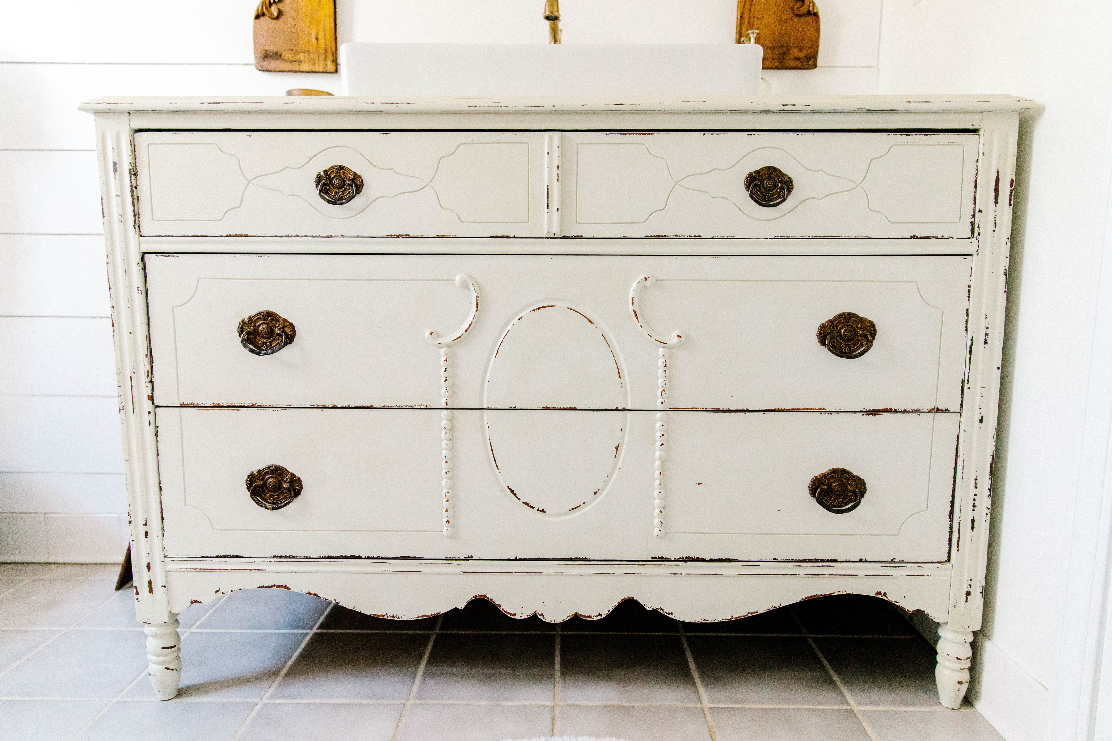 A simple tutorial on how to make a vintage dresser vanity using a vintage dresser and strategic cutting with the additional of a farmhouse sink. 