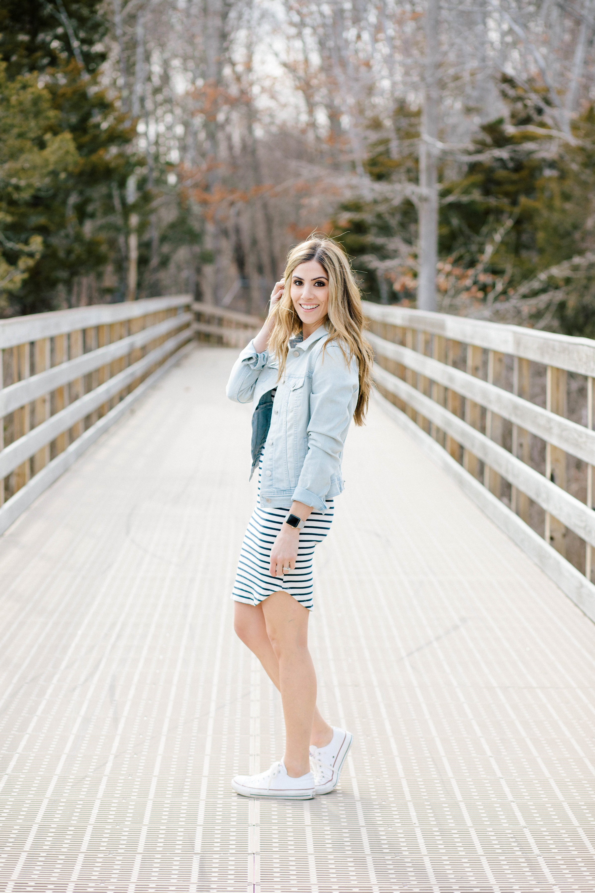 Need inspiration for how to style a striped dress? Adding a simple denim jacket and a pair of casual sneakers is just one of three ways featured in this post!