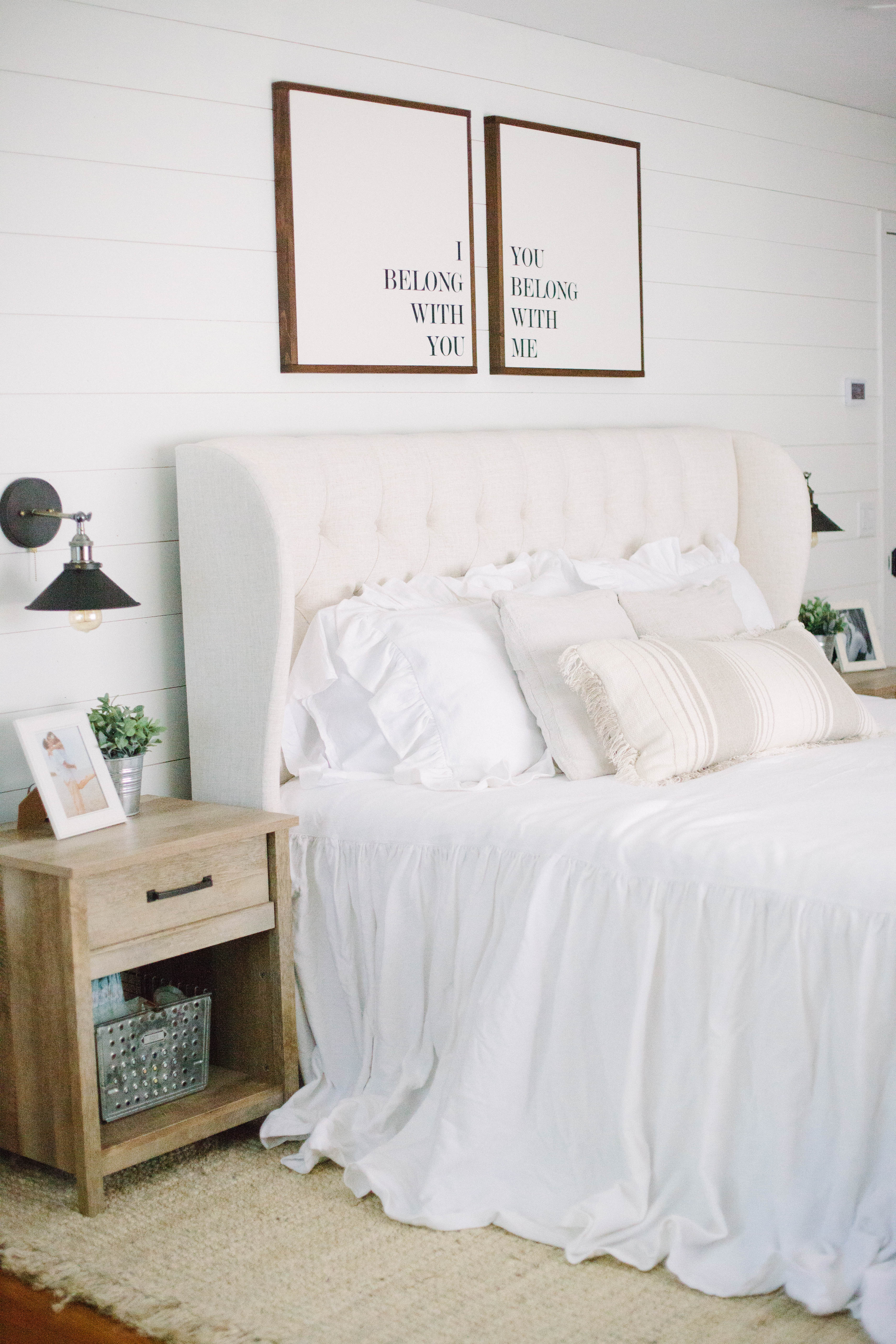 The summer cottage master bedroom is romantic with it's upholstered headboard and waterfall bedding, complete with a jute rug.