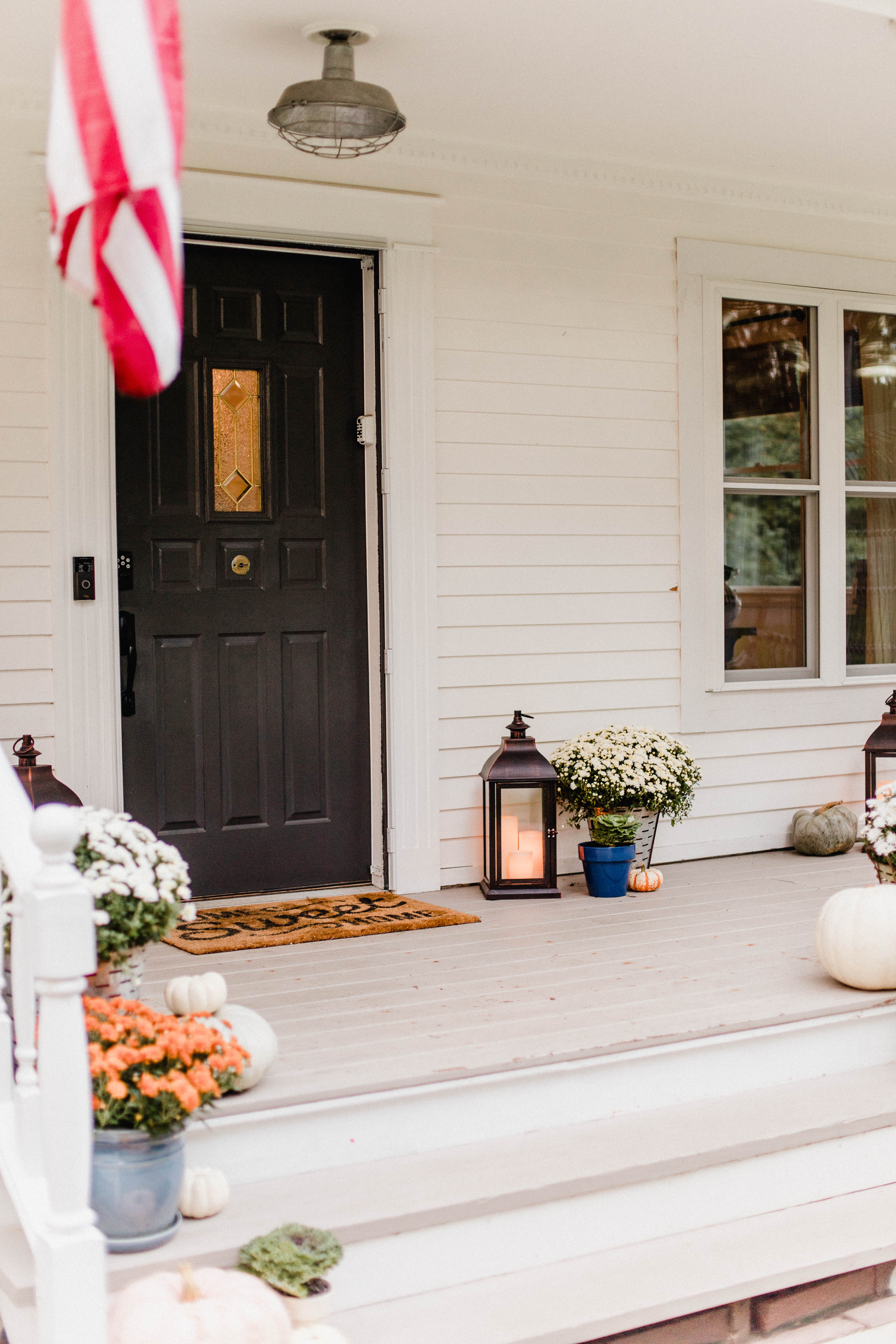 Life and style blogger Lauren McBride shares her Fall Front Porch featuring a mix of natural and vintage elements as well as outdoor lanterns with flameless candles. 