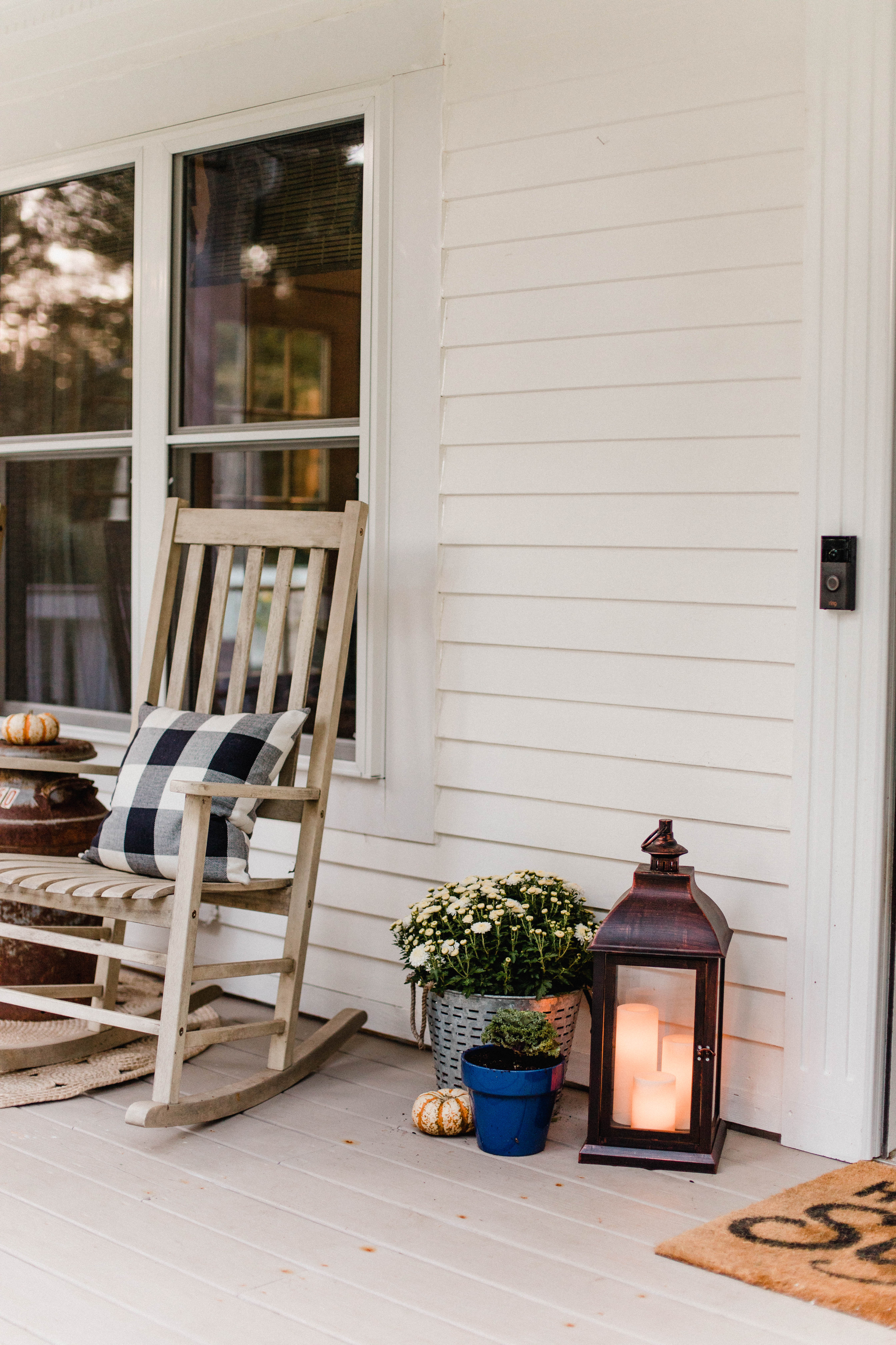 Life and style blogger Lauren McBride shares her Fall Front Porch featuring a mix of natural and vintage elements as well as outdoor lanterns with flameless candles. 