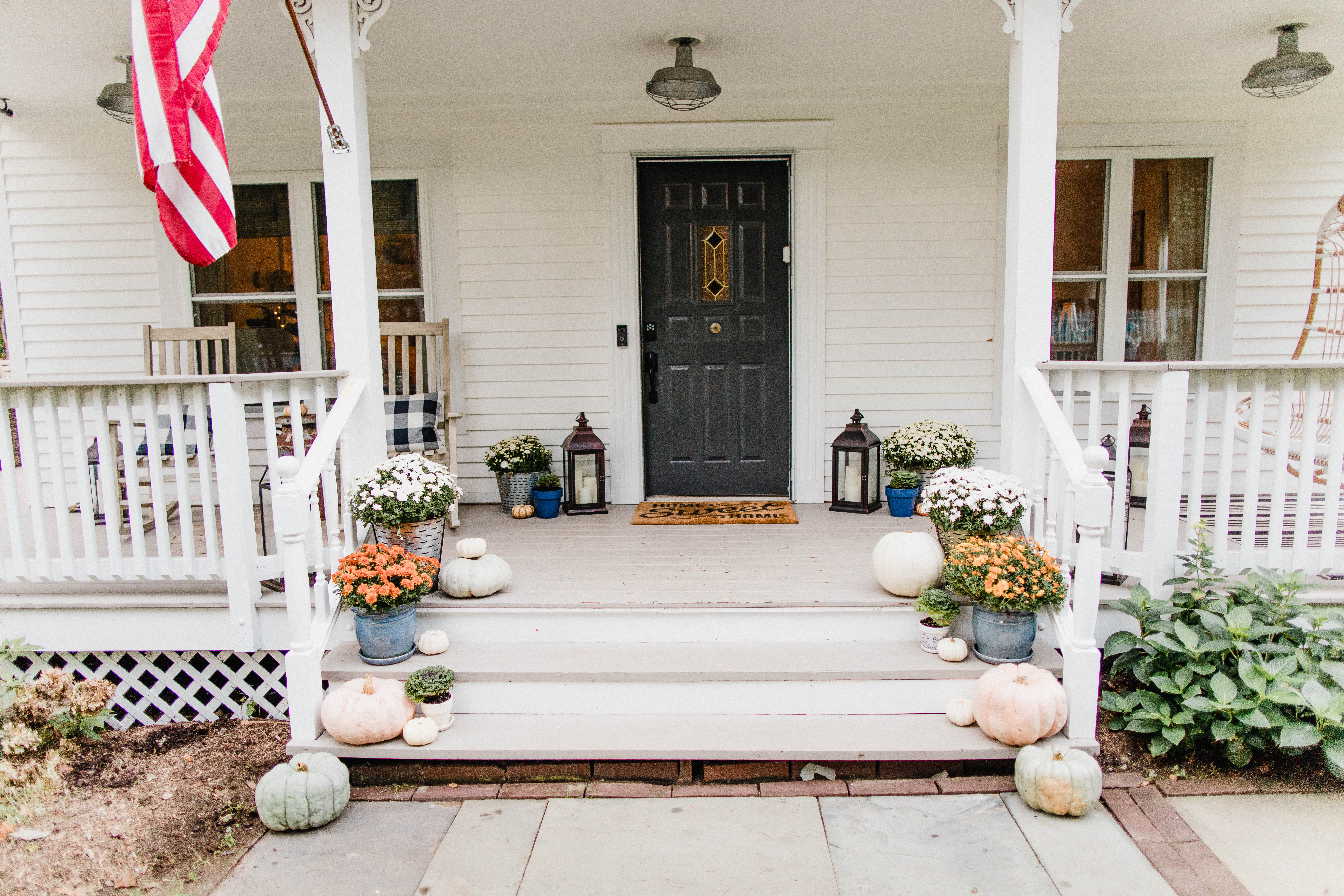 Life and style blogger Lauren McBride shares her Fall Front Porch featuring a mix of natural and vintage elements as well as outdoor lanterns with flameless candles. 