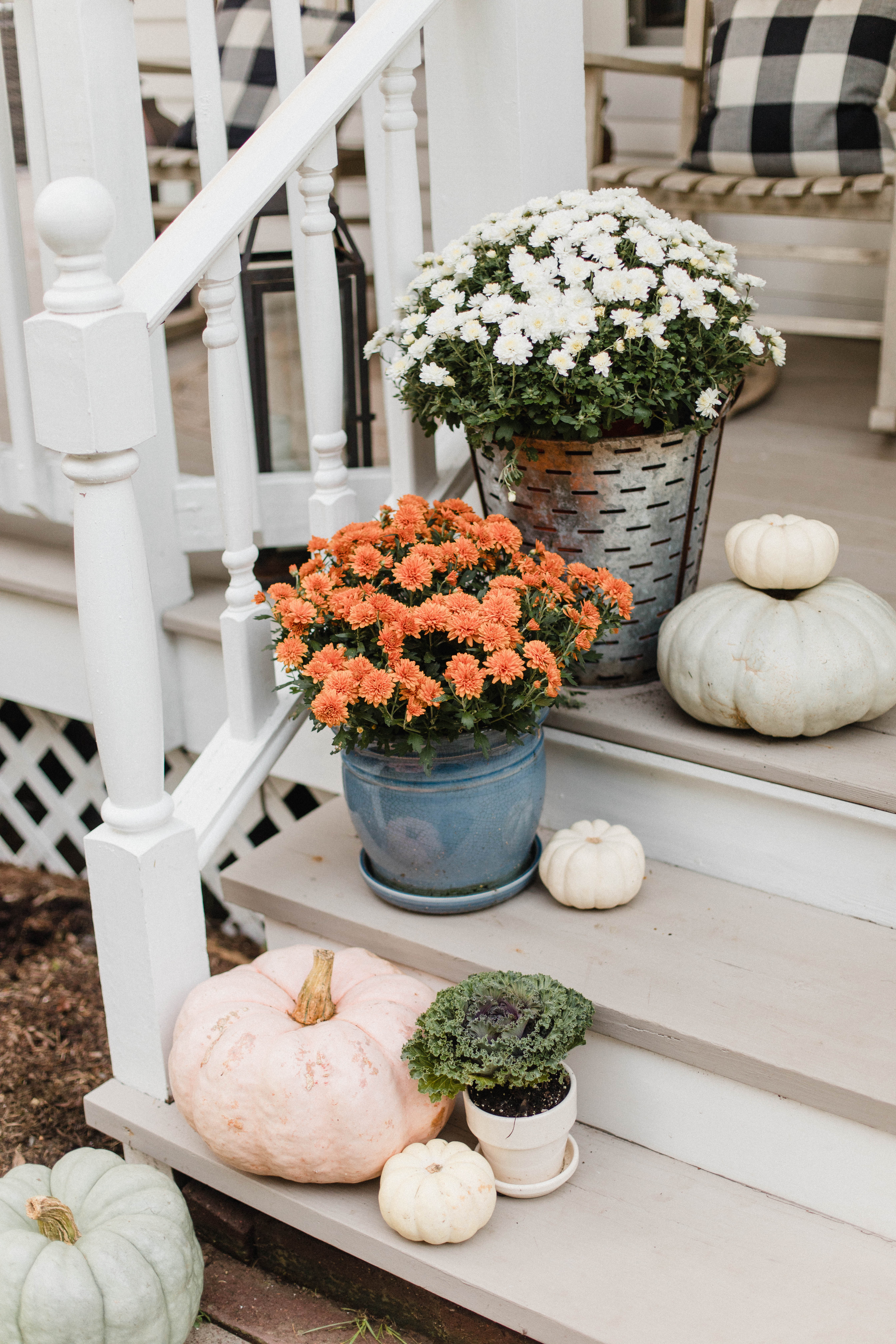 Life and style blogger Lauren McBride shares her Fall Front Porch featuring a mix of natural and vintage elements as well as outdoor lanterns with flameless candles. 