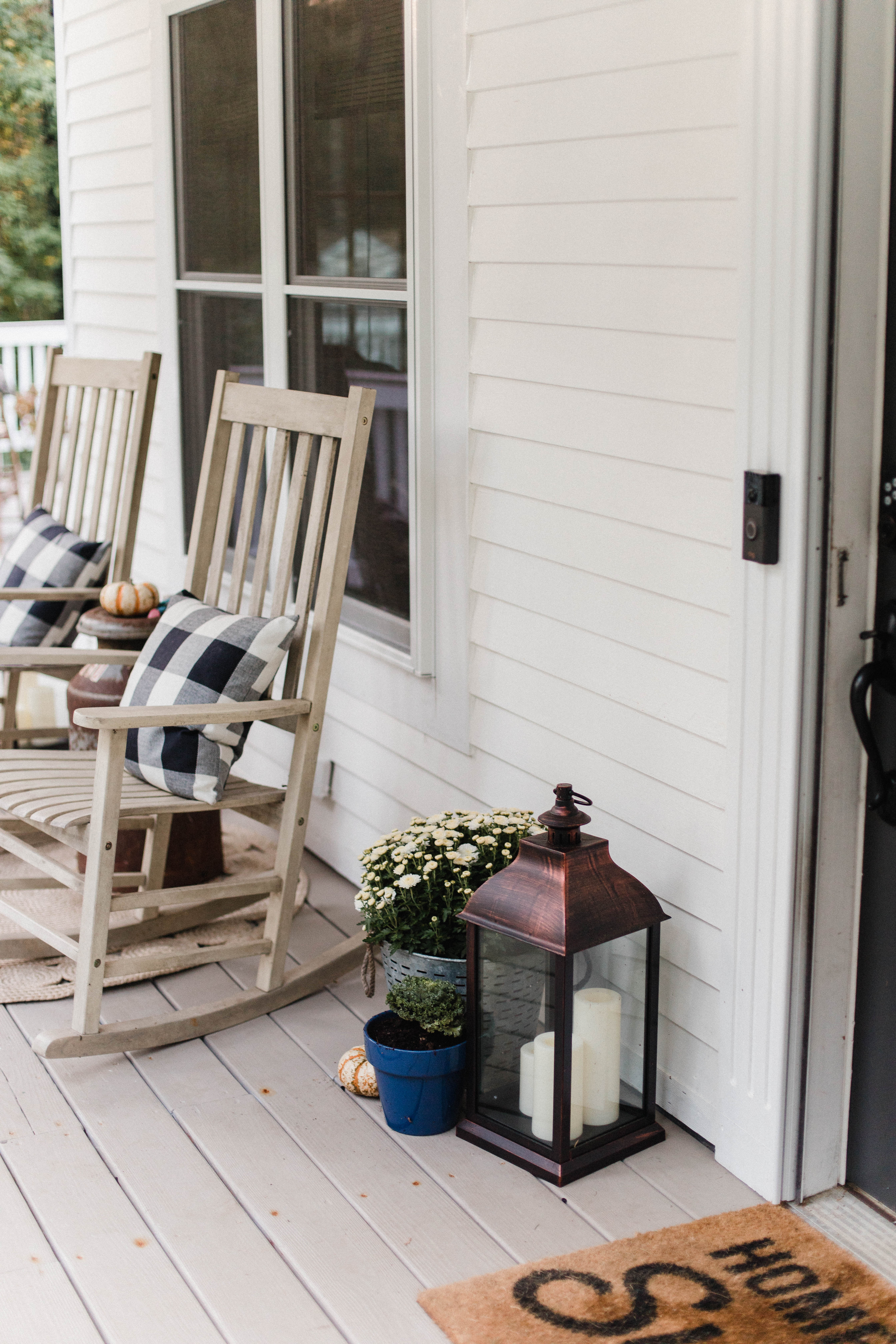 Life and style blogger Lauren McBride shares her Fall Front Porch featuring a mix of natural and vintage elements as well as outdoor lanterns with flameless candles. 