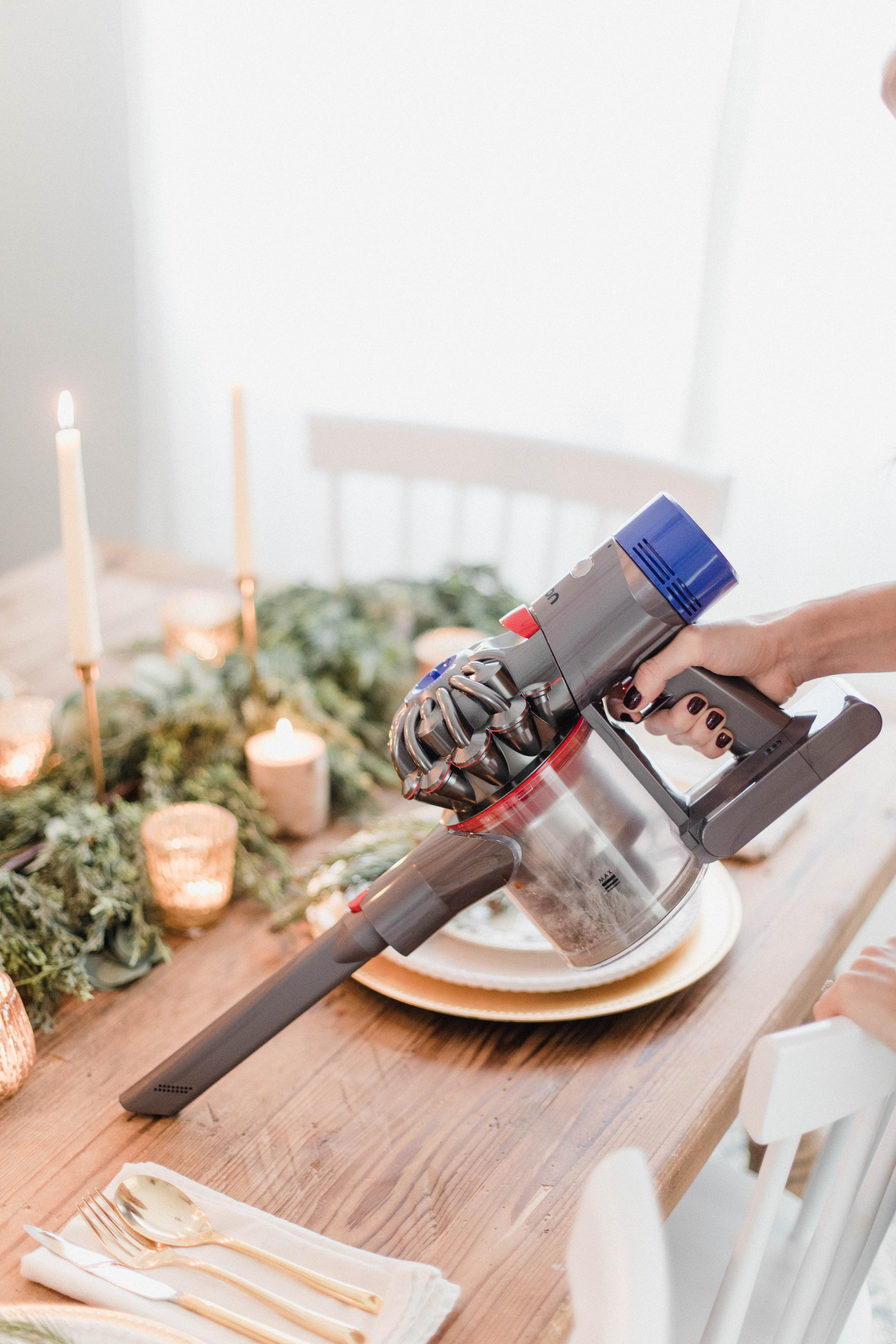 Connecticut life and style blogger Lauren McBride shares a white and gold Christmas tablescape featuring a mix of faux greenery, metallics, and antique touches. 