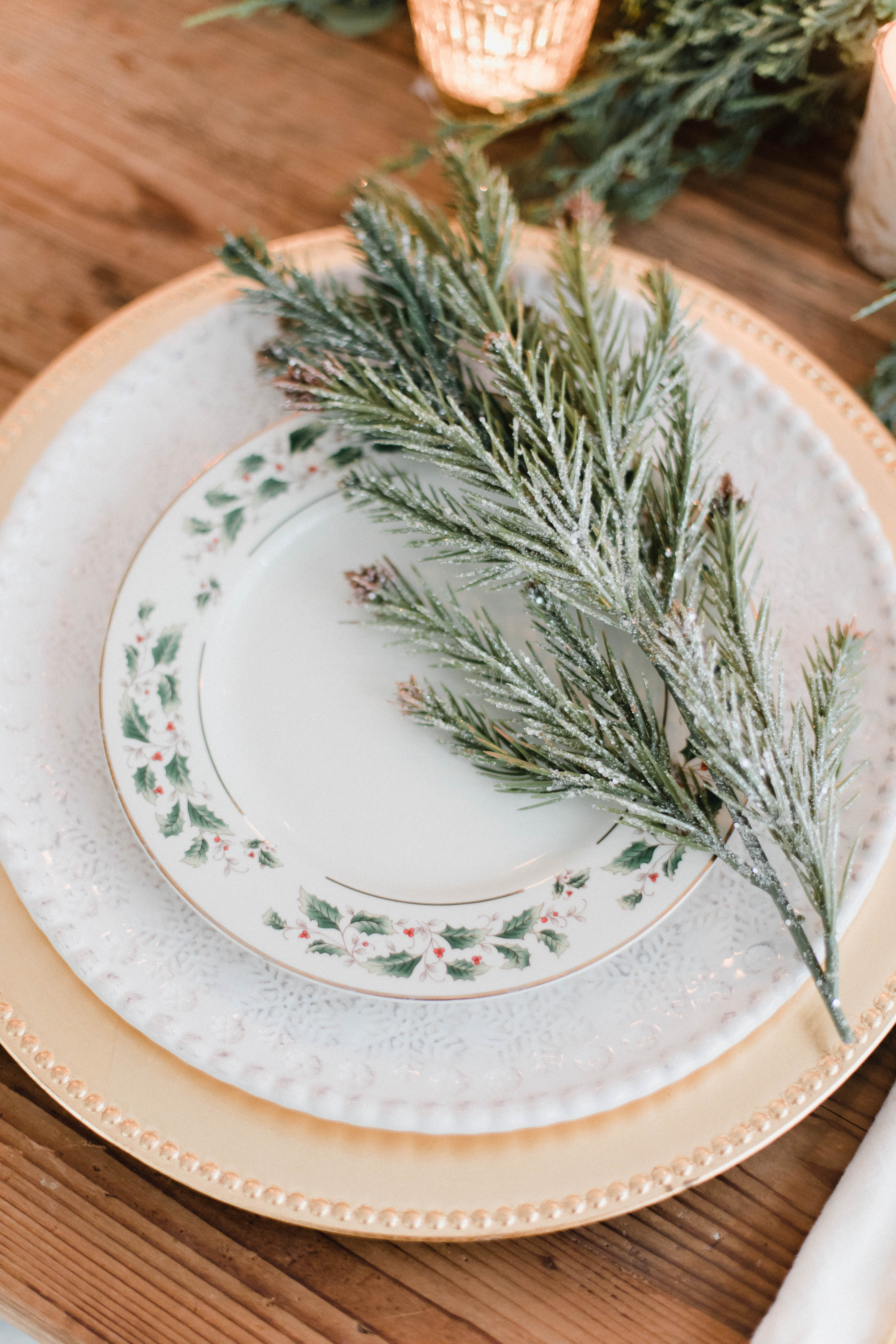 Connecticut life and style blogger Lauren McBride shares a white and gold Christmas tablescape featuring a mix of faux greenery, metallics, and antique touches. 