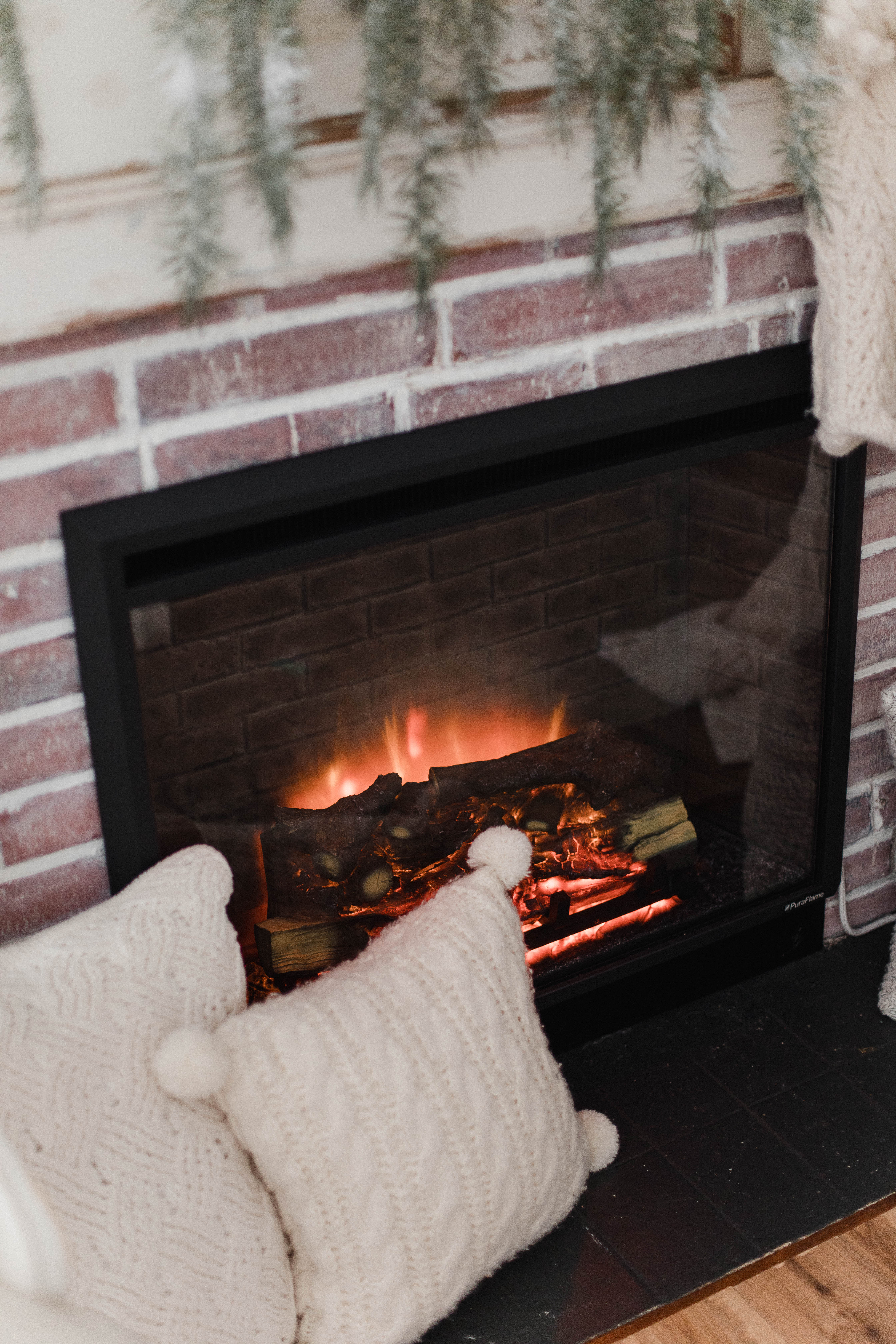 Connecticut life and style blogger Lauren McBride shares about the installation of an electric fireplace in her home and the benefits vs. a real fireplace.