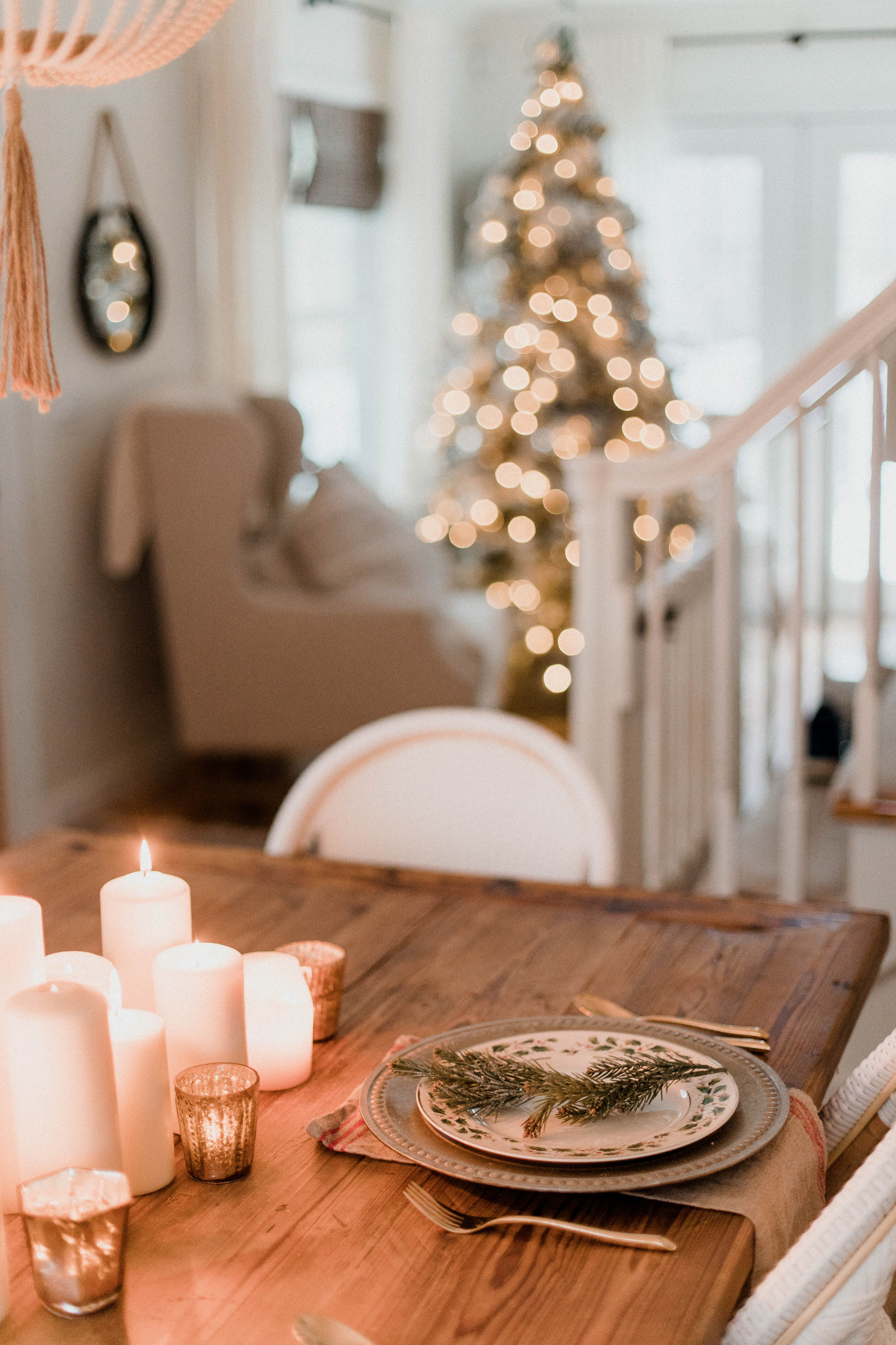 Connecticut life and style blogger Lauren McBride shares a Romantic Holiday Tablescape featuring romantic, cozy vibes with candles and a festive place setting.