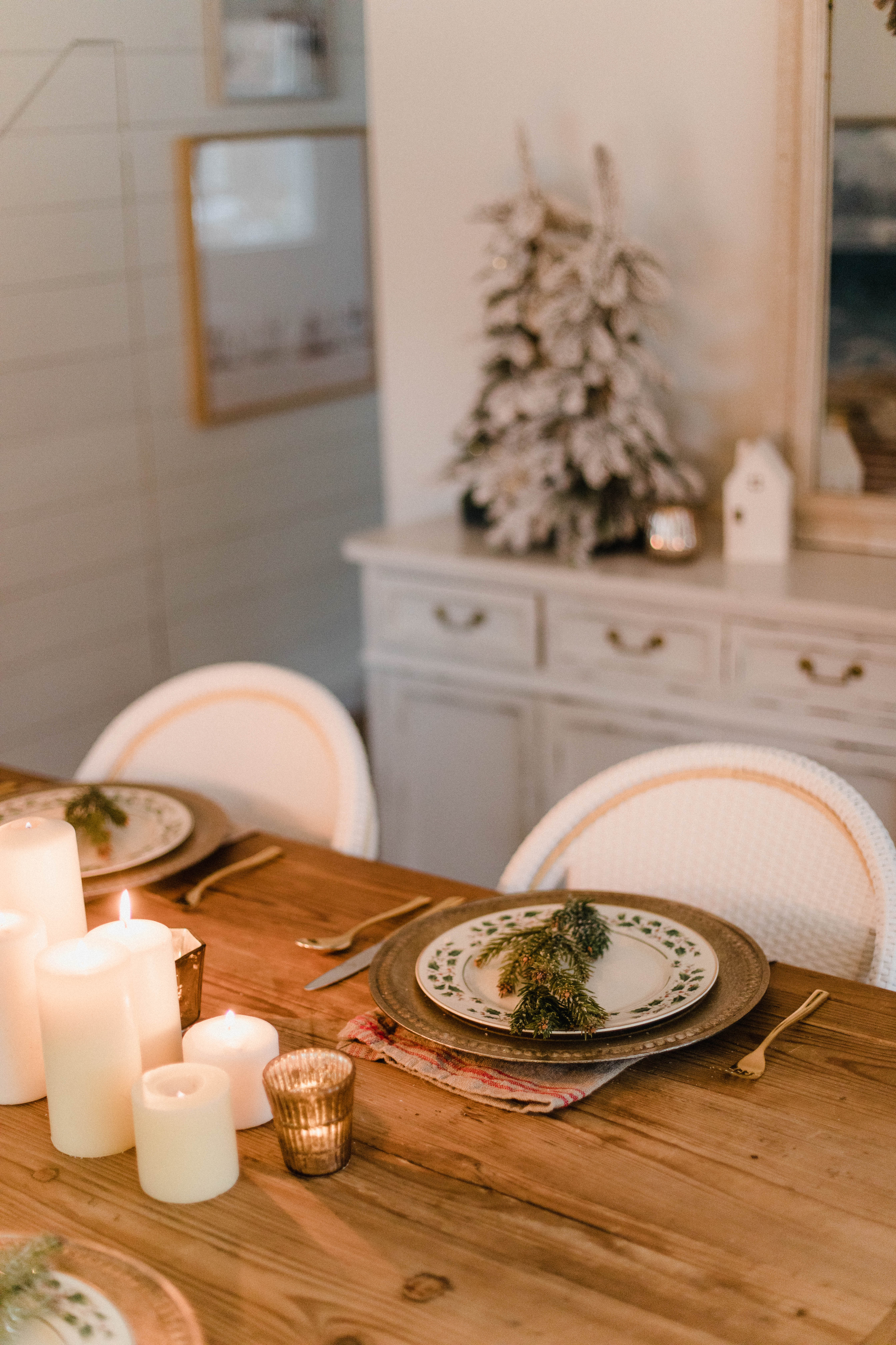 Connecticut life and style blogger Lauren McBride shares a Romantic Holiday Tablescape featuring romantic, cozy vibes with candles and a festive place setting.