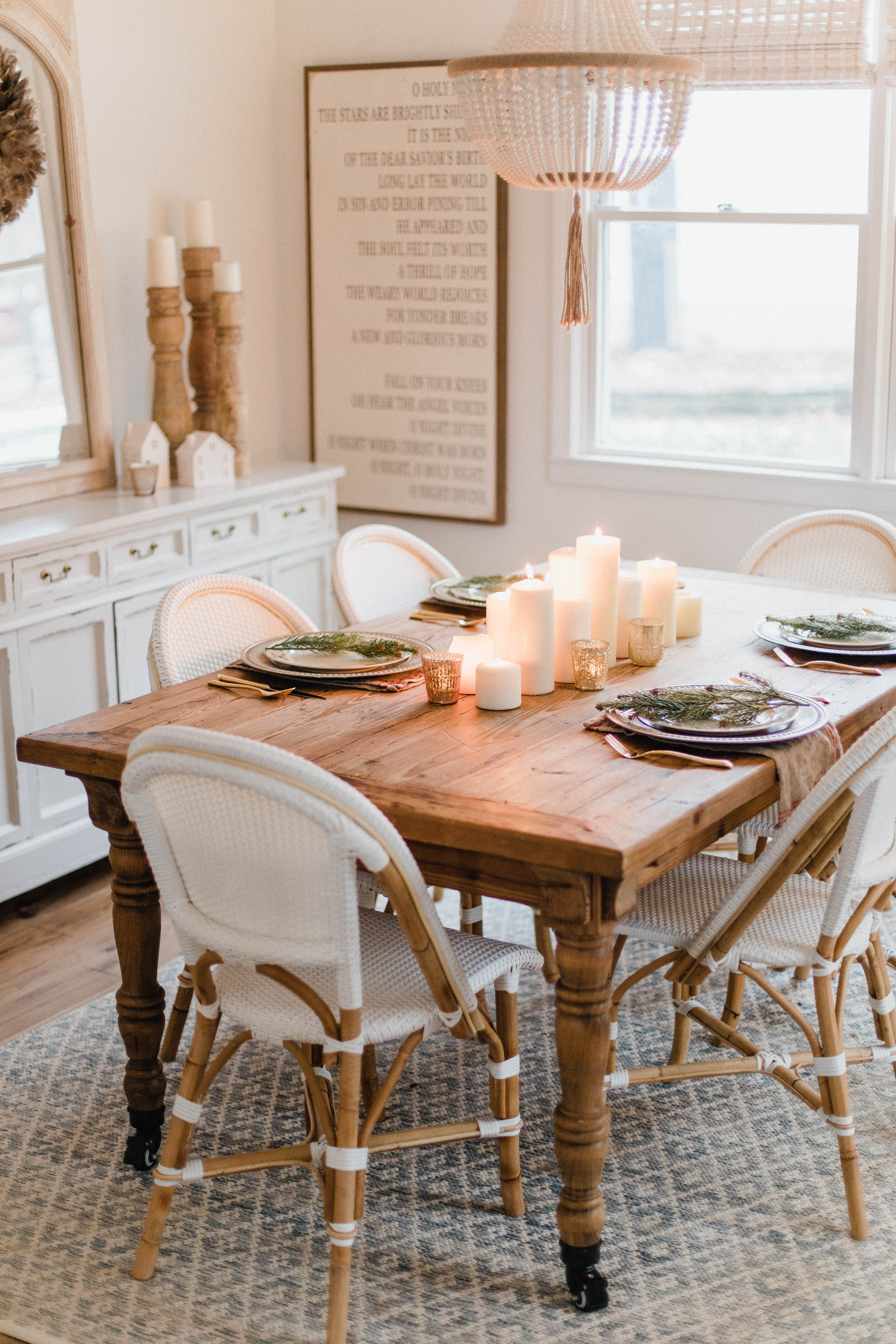 Connecticut life and style blogger Lauren McBride shares a Romantic Holiday Tablescape featuring romantic, cozy vibes with candles and a festive place setting.