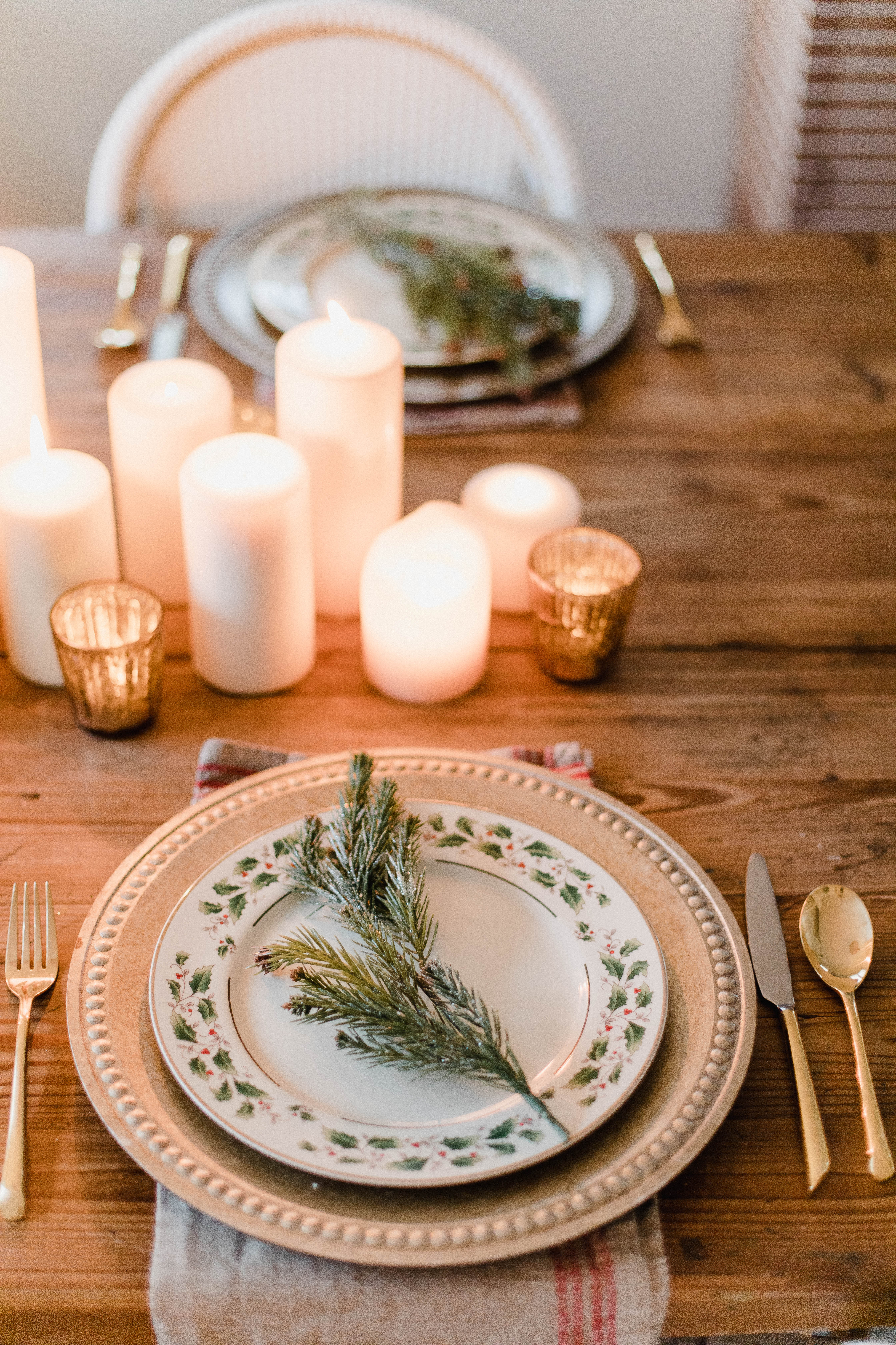 Connecticut life and style blogger Lauren McBride shares a Romantic Holiday Tablescape featuring romantic, cozy vibes with candles and a festive place setting.