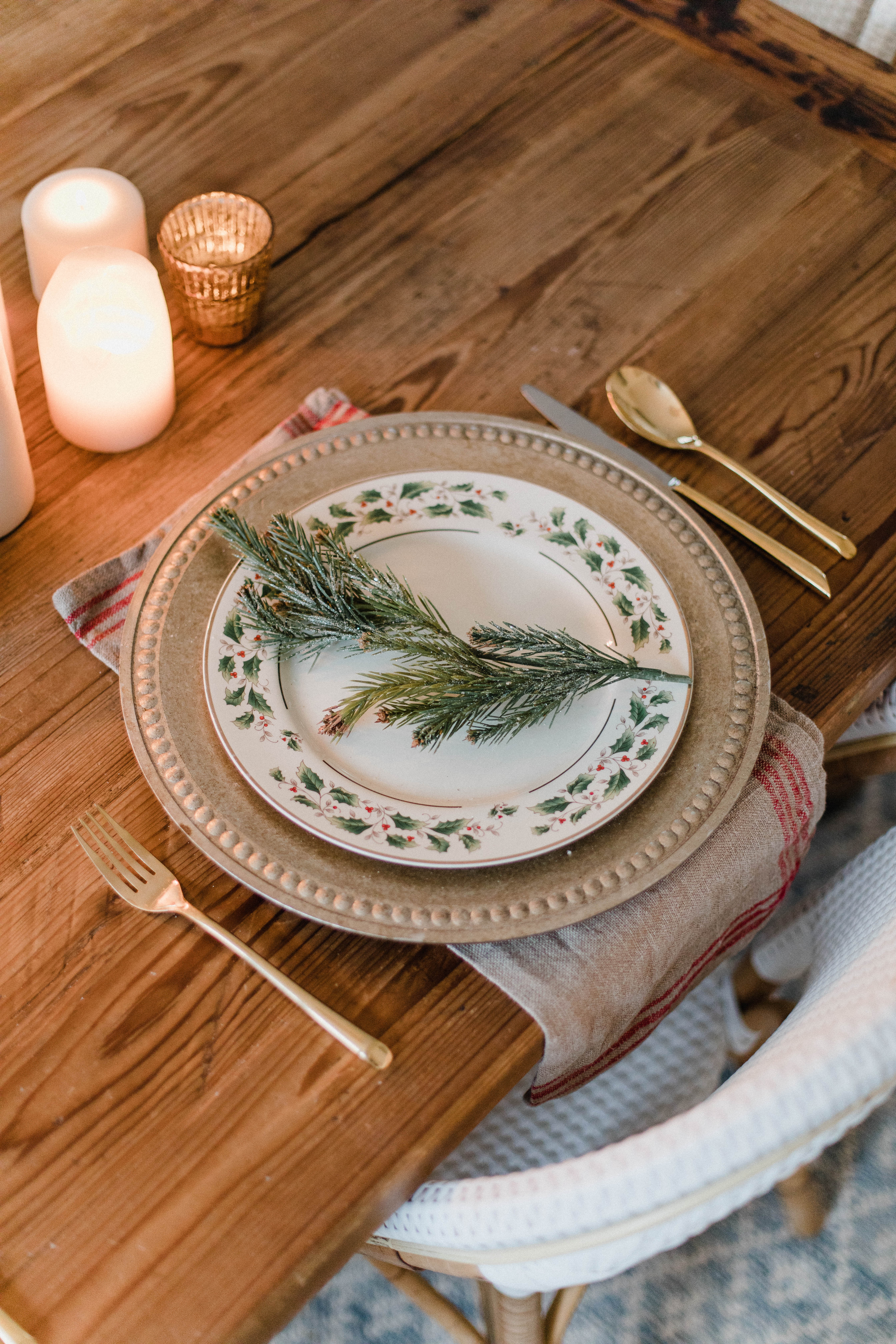 Connecticut life and style blogger Lauren McBride shares a Romantic Holiday Tablescape featuring romantic, cozy vibes with candles and a festive place setting.