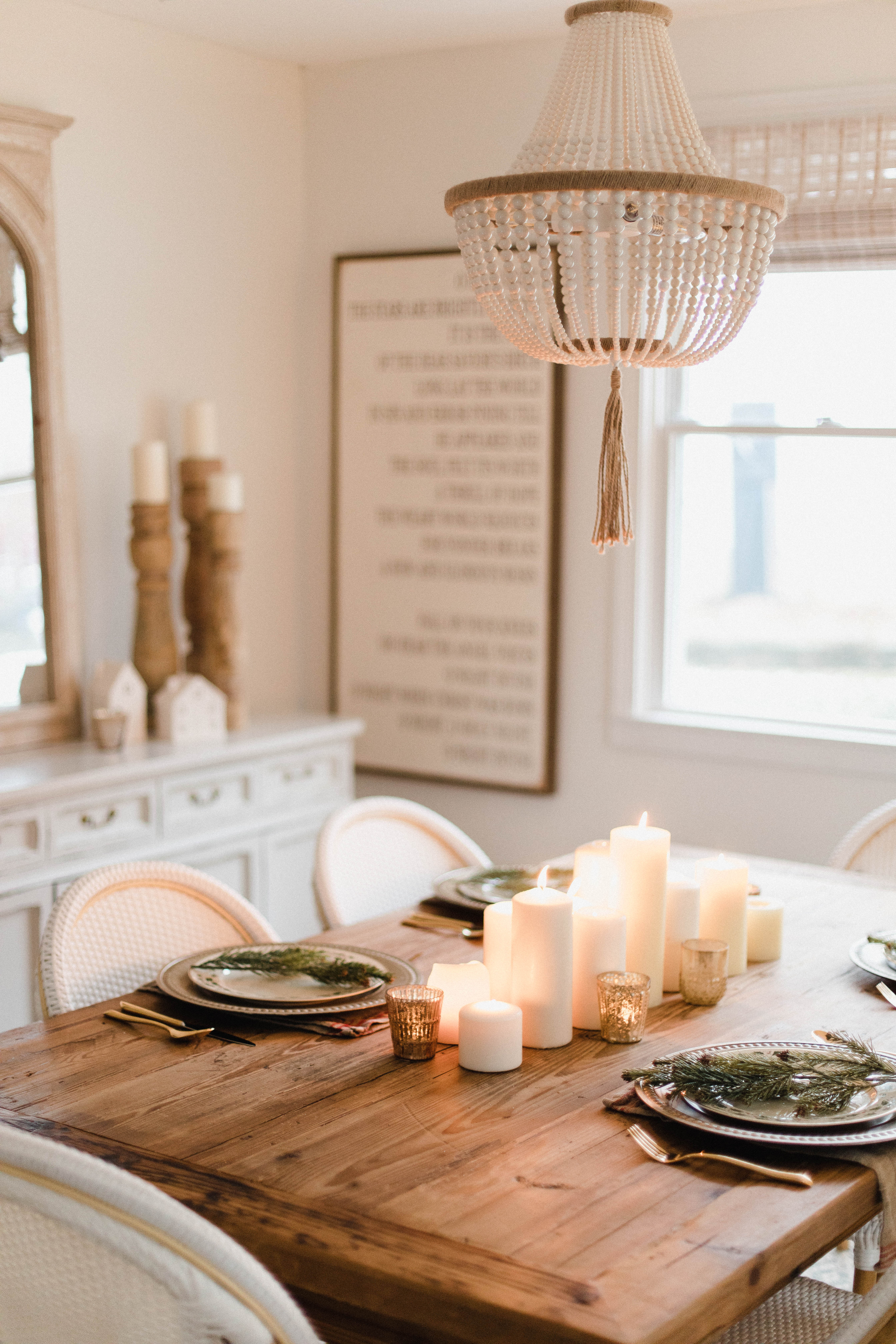 Connecticut life and style blogger Lauren McBride shares a Romantic Holiday Tablescape featuring romantic, cozy vibes with candles and a festive place setting.