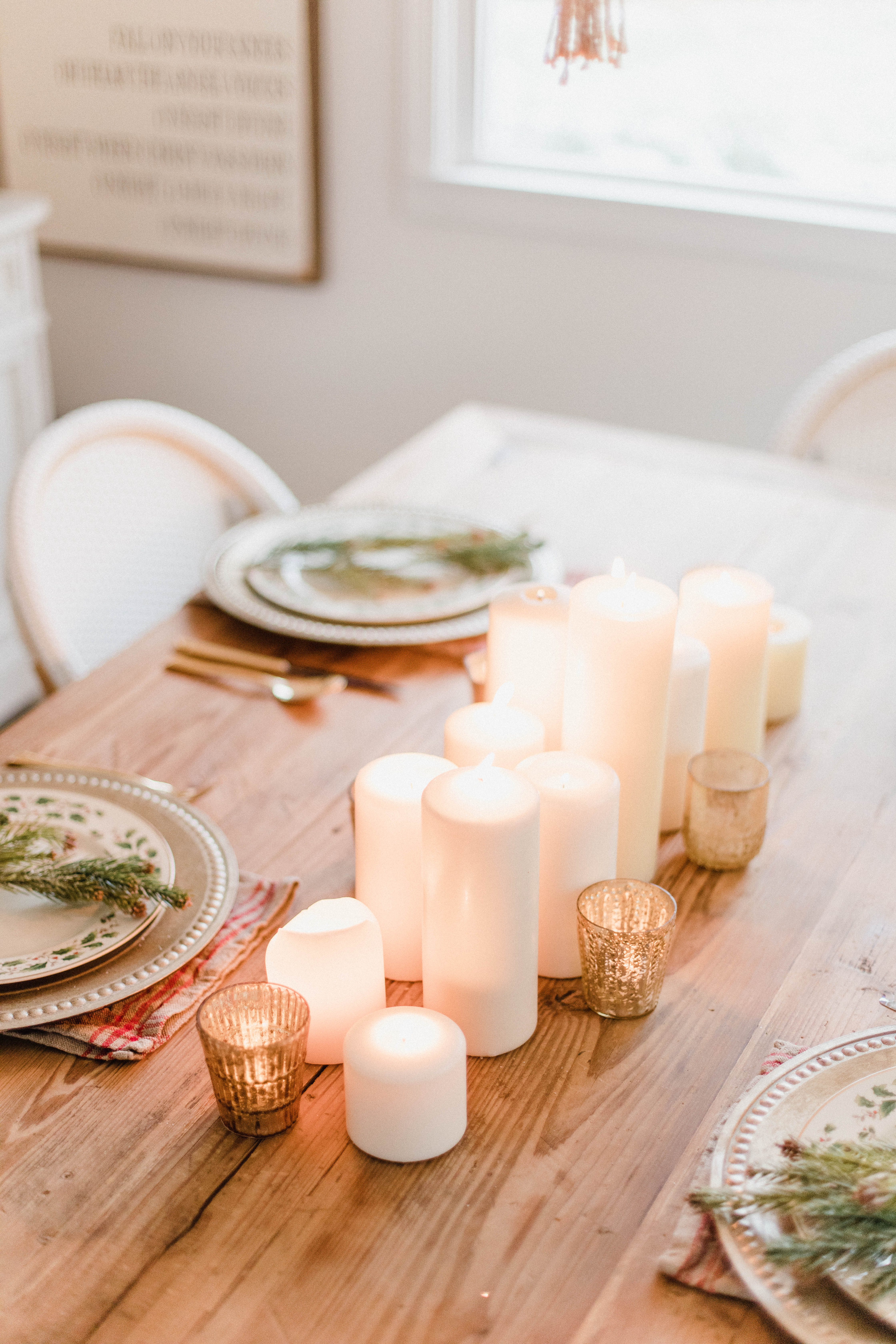 Connecticut life and style blogger Lauren McBride shares a Romantic Holiday Tablescape featuring romantic, cozy vibes with candles and a festive place setting.
