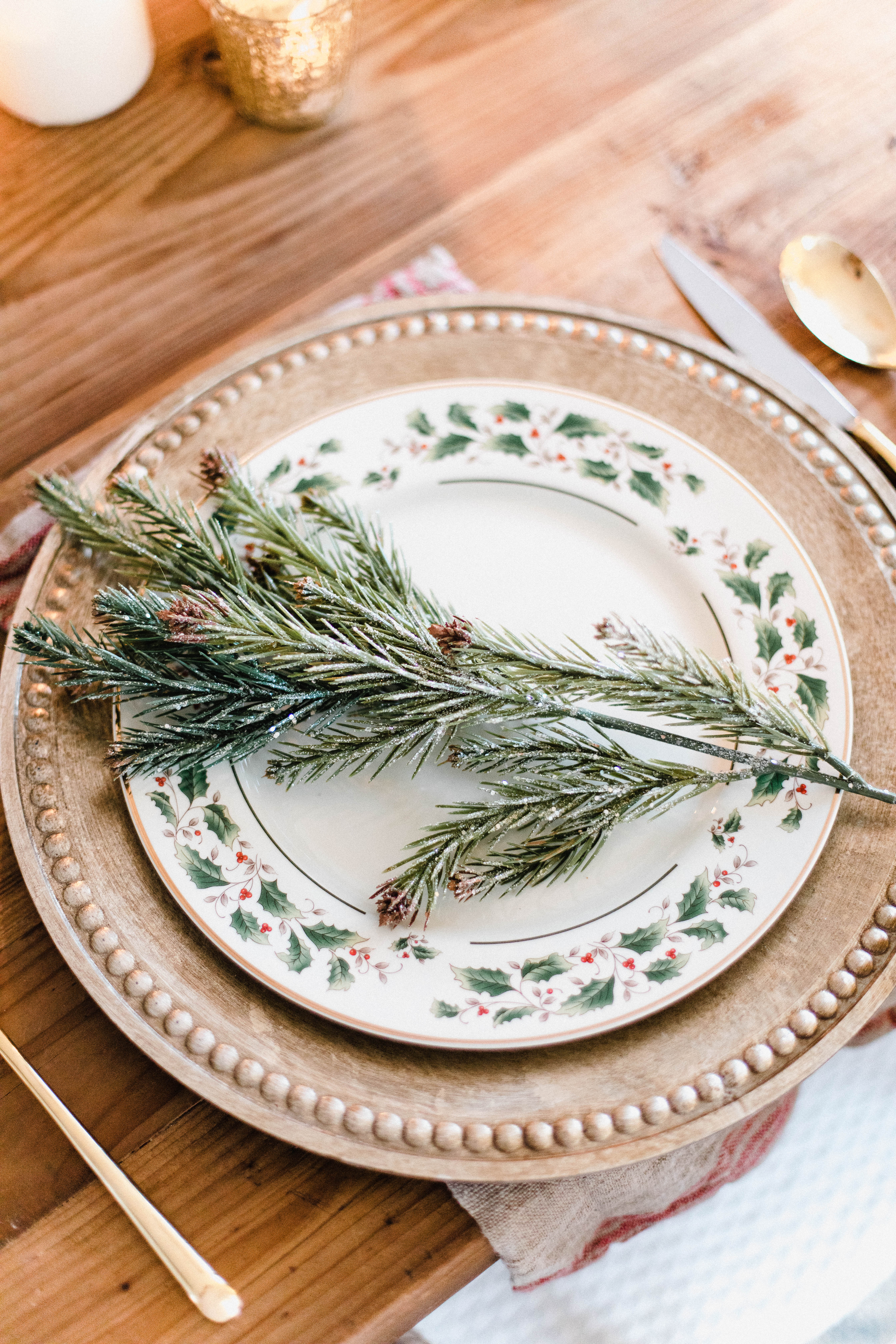 Connecticut life and style blogger Lauren McBride shares a Romantic Holiday Tablescape featuring romantic, cozy vibes with candles and a festive place setting.