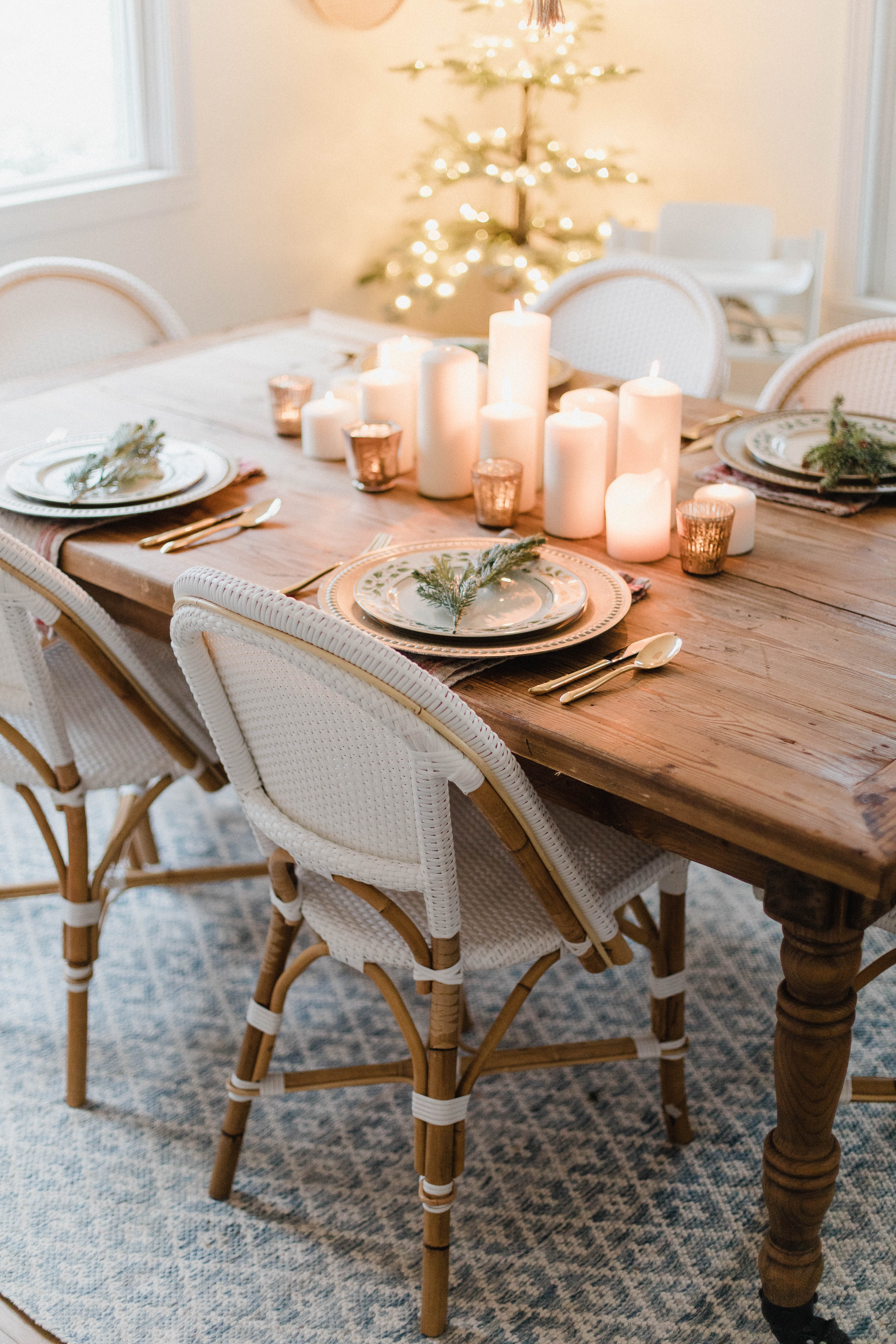 Connecticut life and style blogger Lauren McBride shares a Romantic Holiday Tablescape featuring romantic, cozy vibes with candles and a festive place setting.