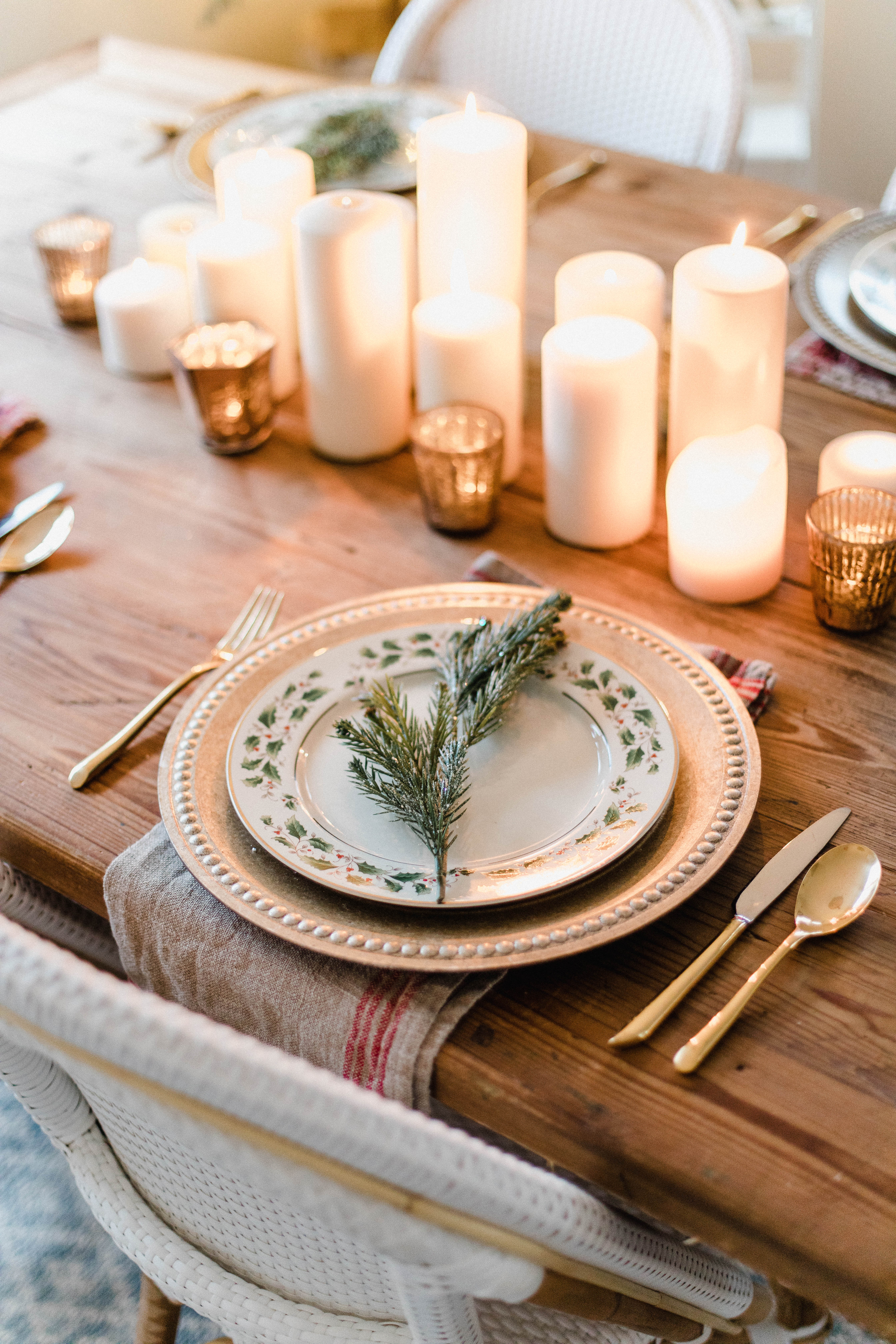 Connecticut life and style blogger Lauren McBride shares a Romantic Holiday Tablescape featuring romantic, cozy vibes with candles and a festive place setting.