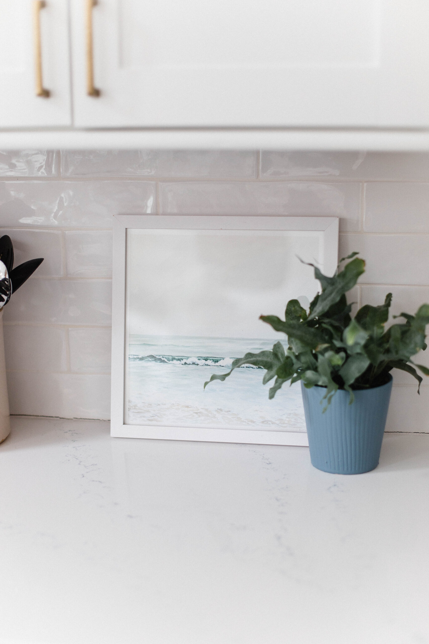 Connecticut life and style blogger Lauren McBride shares the coastal artwork in her modern coastal inspired home.